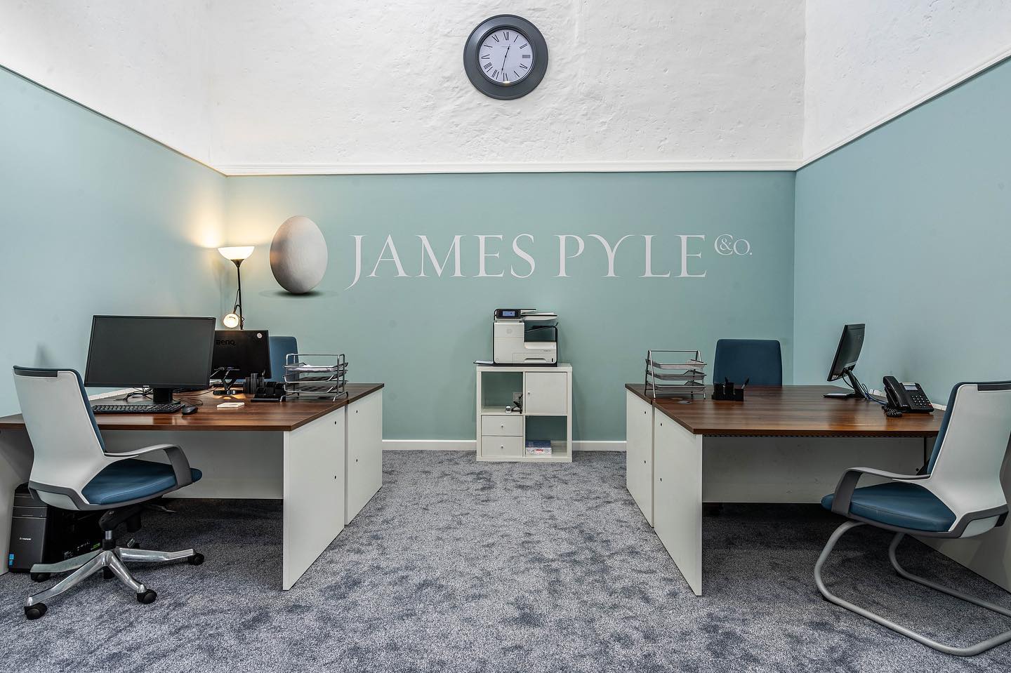 A james pyle office with two desks and chairs