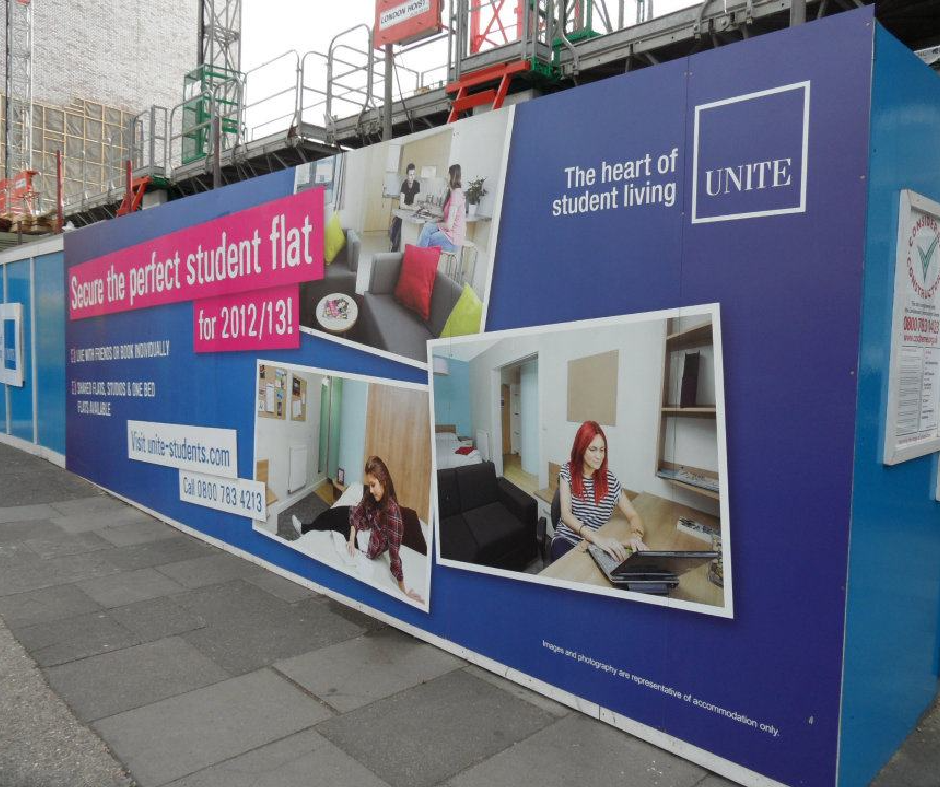 A building under construction with a sign that says