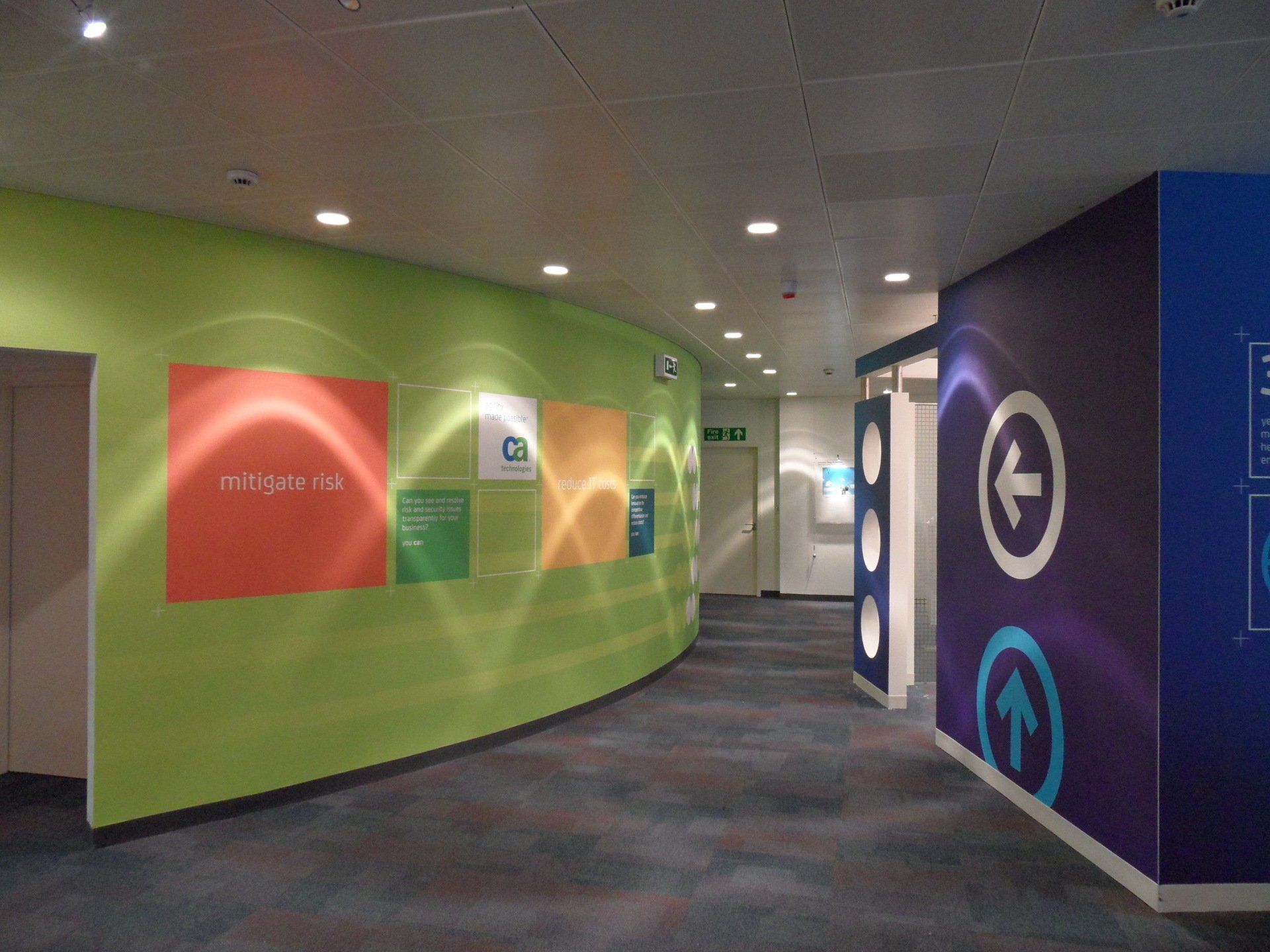 A hallway with colorful walls and arrows pointing in different directions
