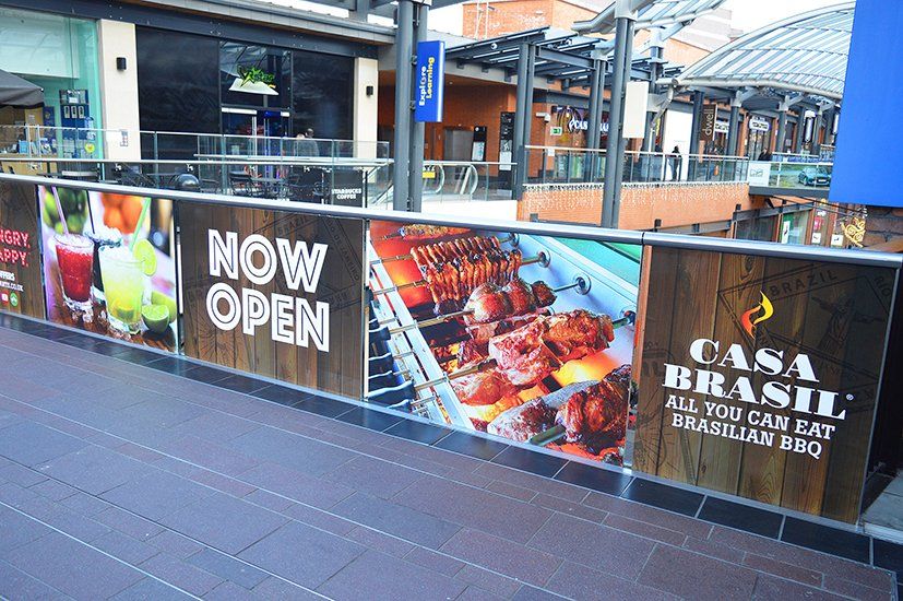 A building with a sign that says now open on it