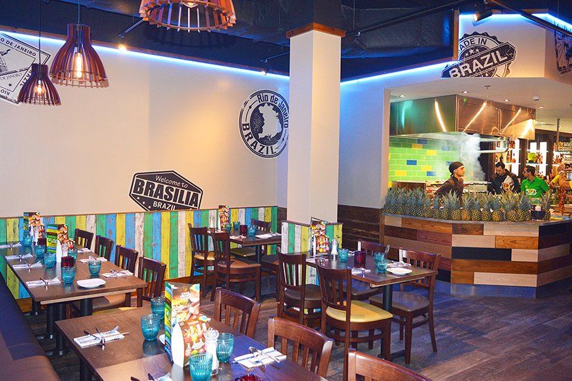 A restaurant with tables and chairs and a sign that says brazil