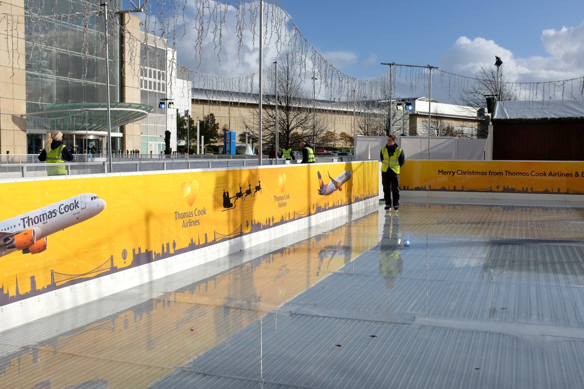 An ice rink with a plane on the side of it