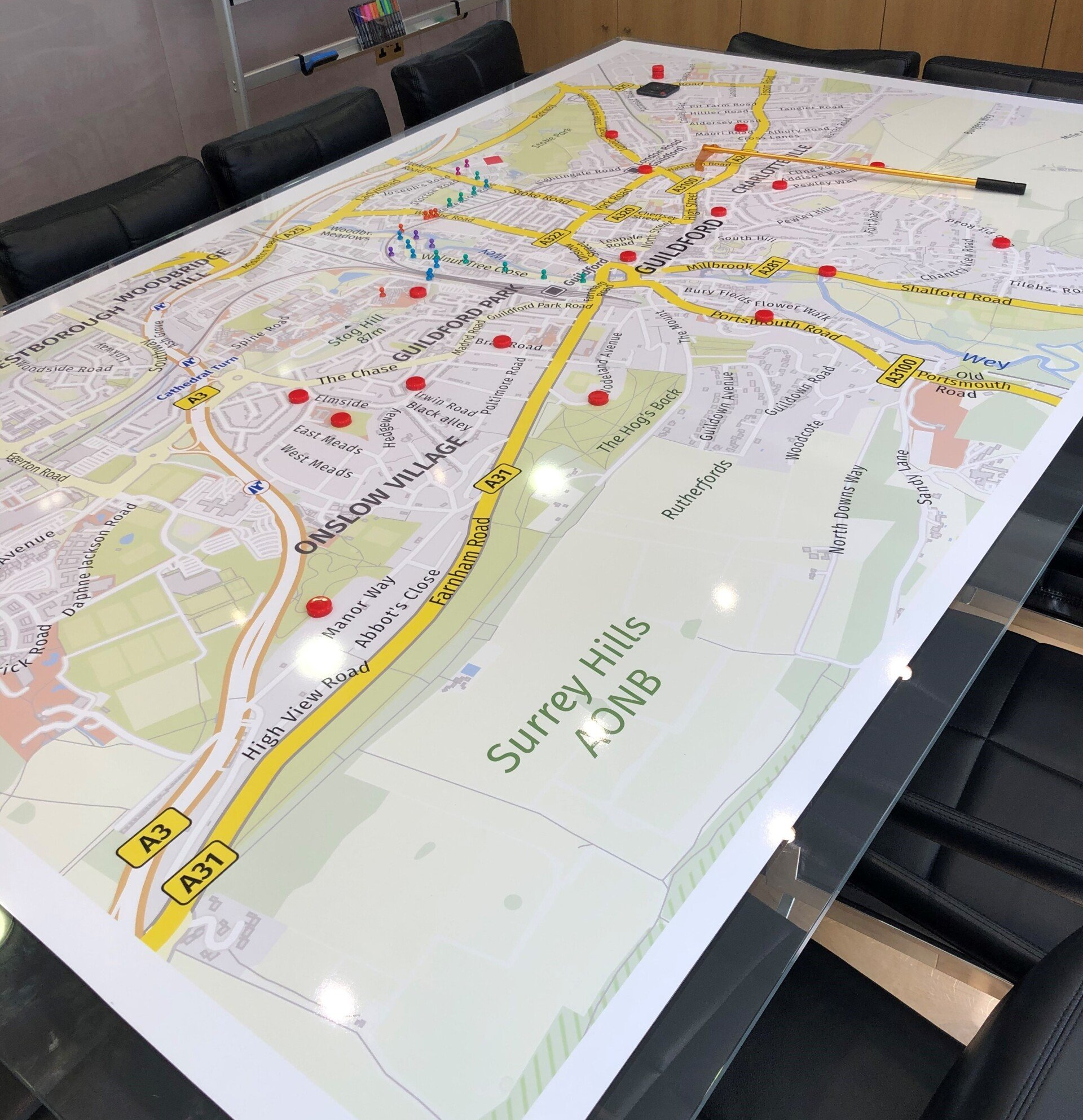 A large map of surrey hills is on a table