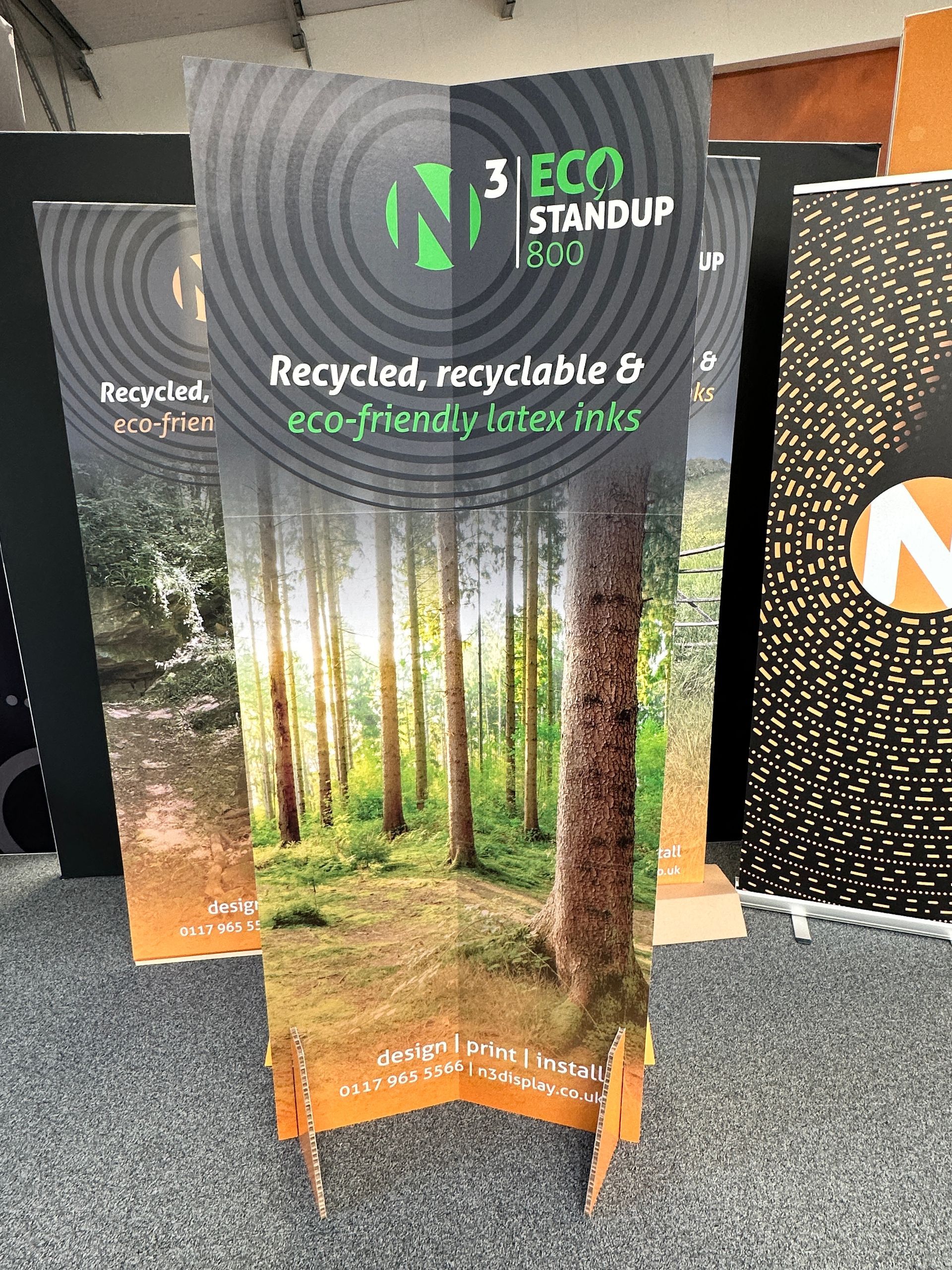 A cardboard stand up with a picture of trees on it