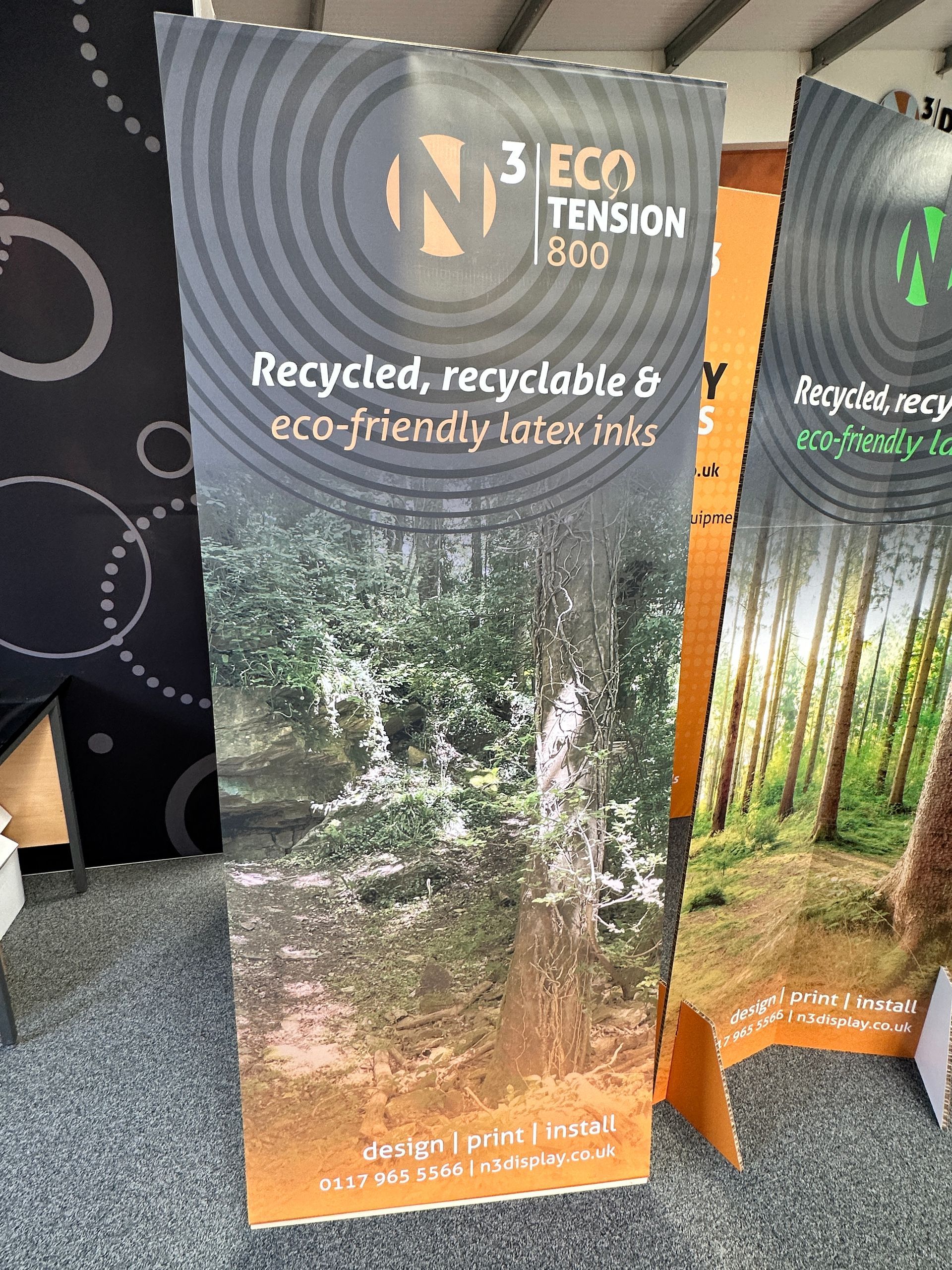 A sign that says ' recycled , recyclable & eco-friendly latex ink ' on it