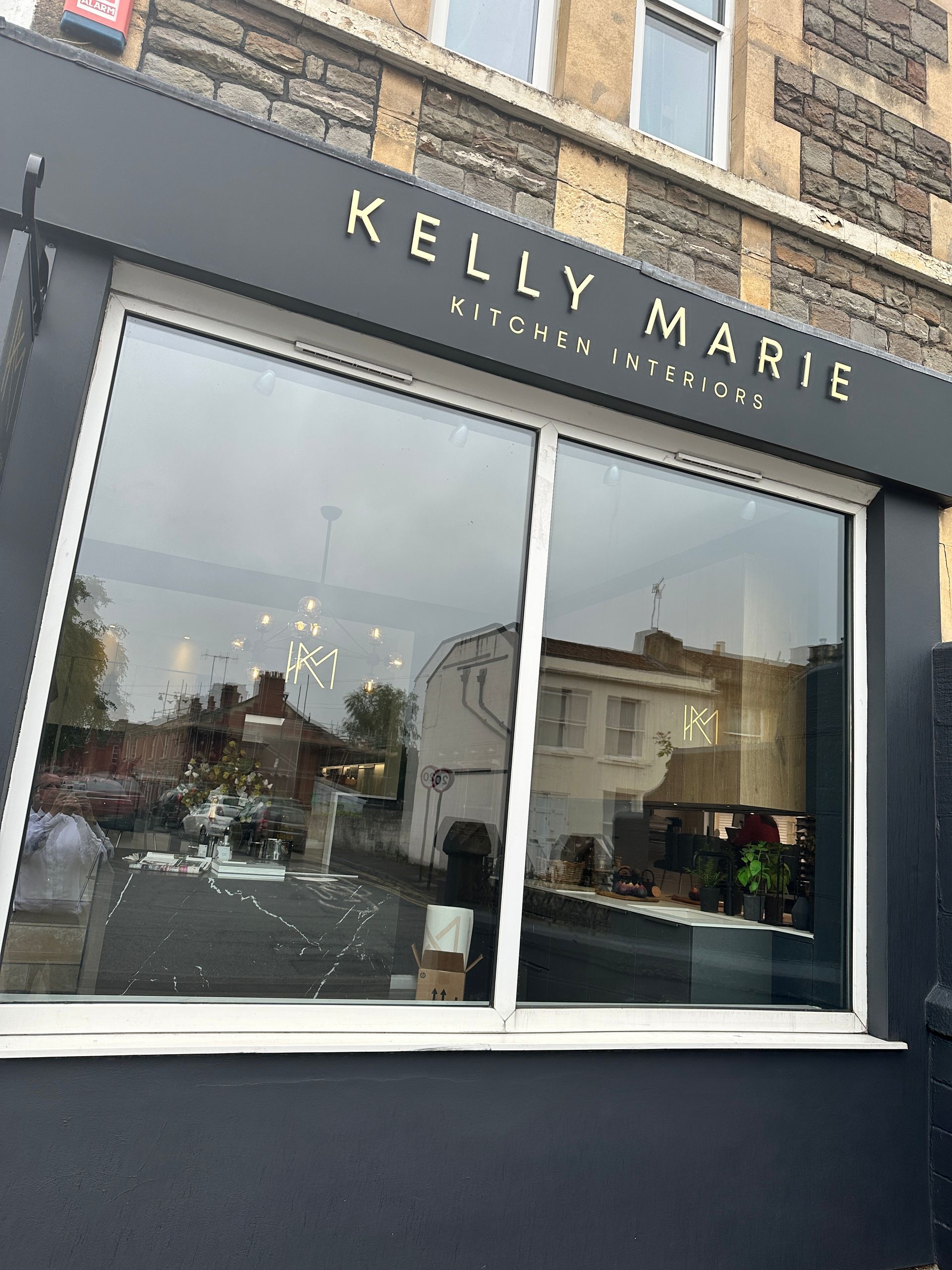A store front with a large window and a sign that says kelly marie.