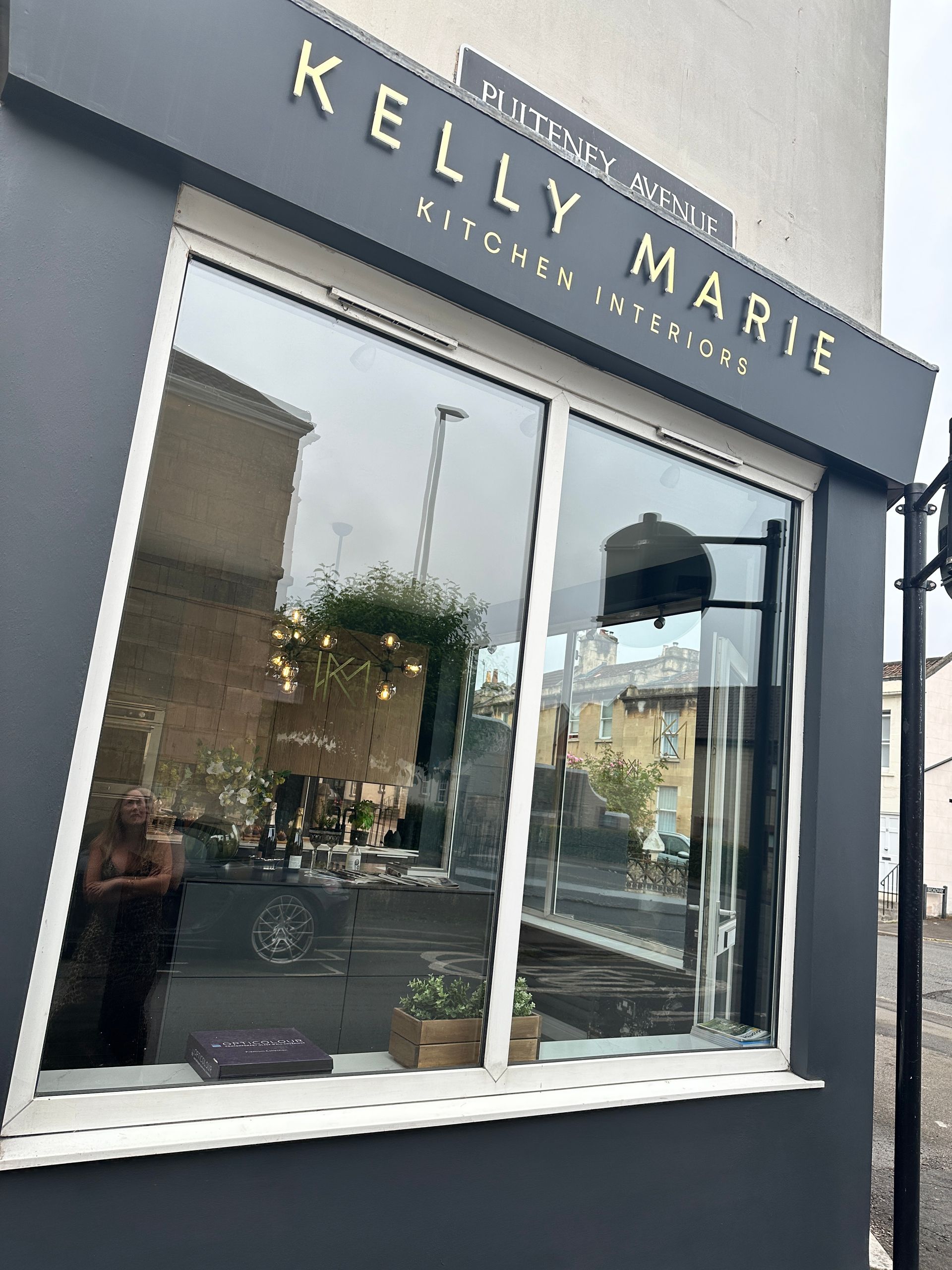 A store front with a large window and a sign that says kelly marie.