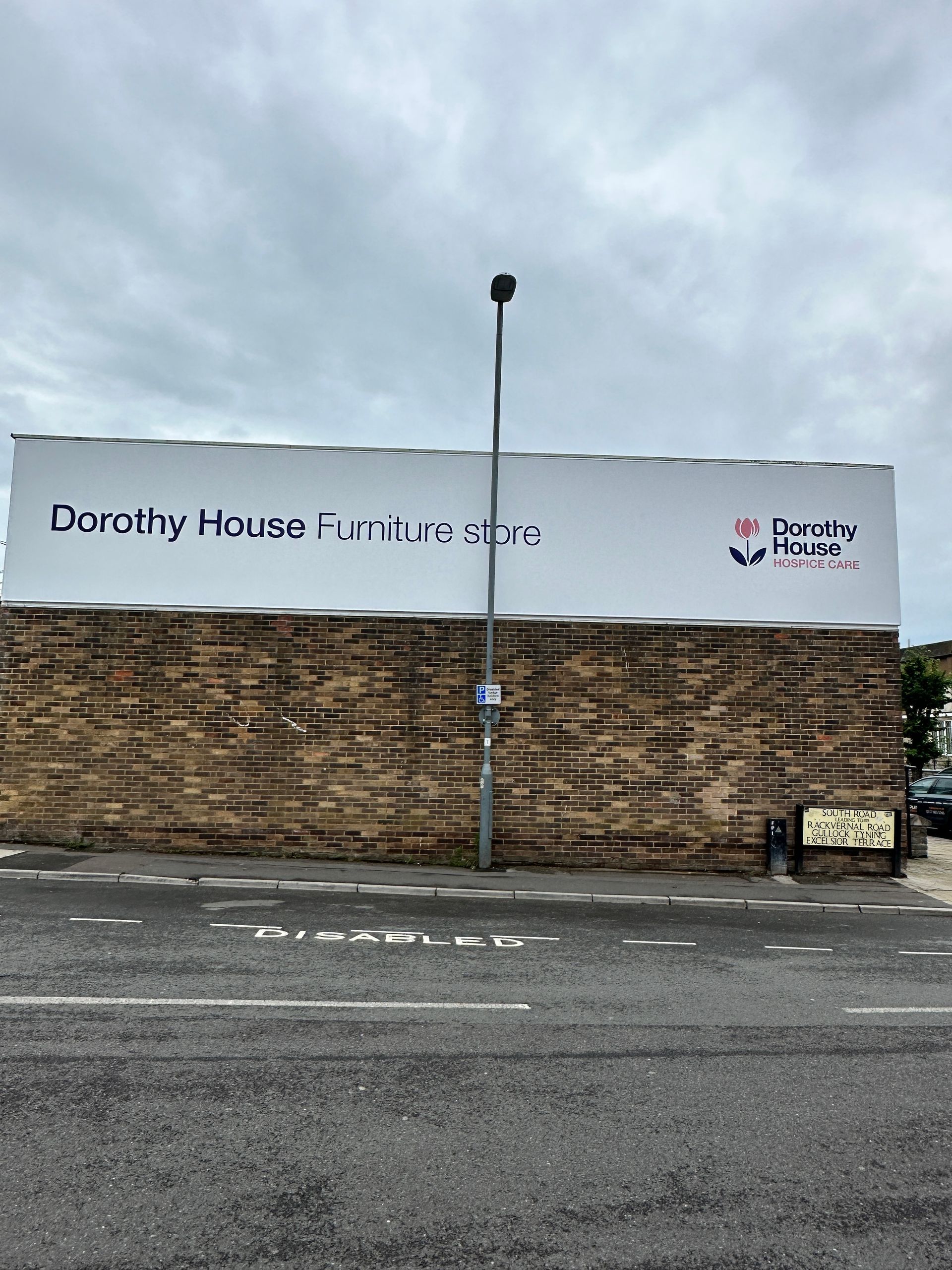 A large billboard on the side of a building that says dorothy house furniture