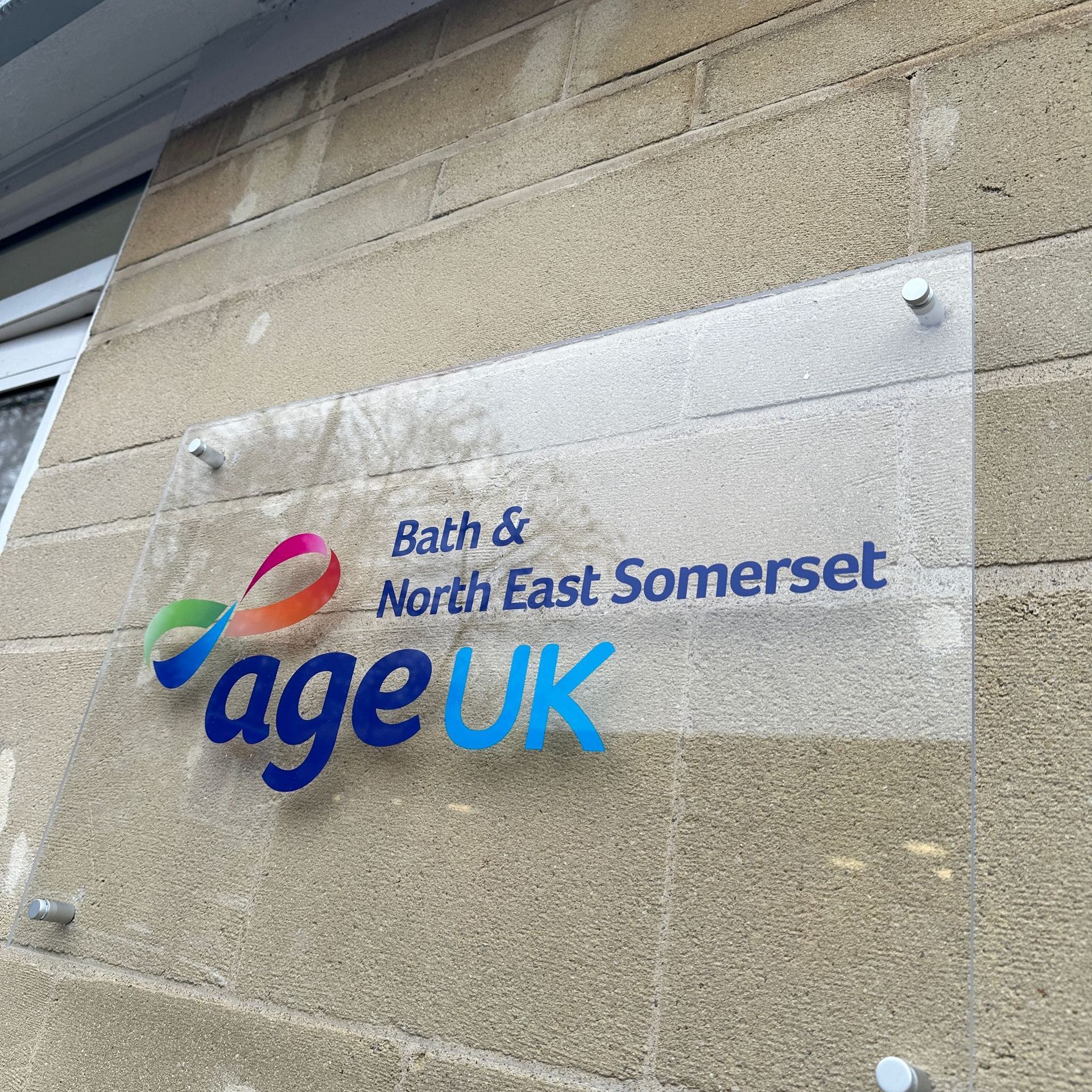 A sign on a brick wall that says bath & north east somerset