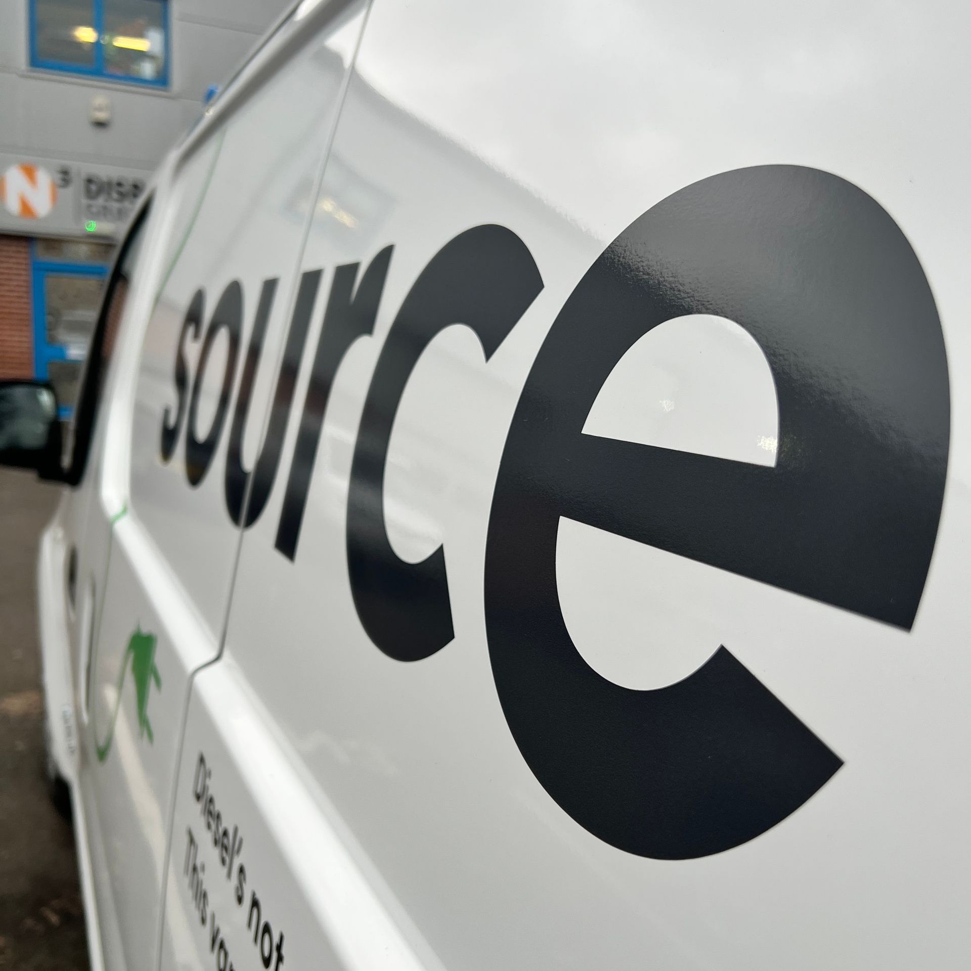 A white van with the word source on the side