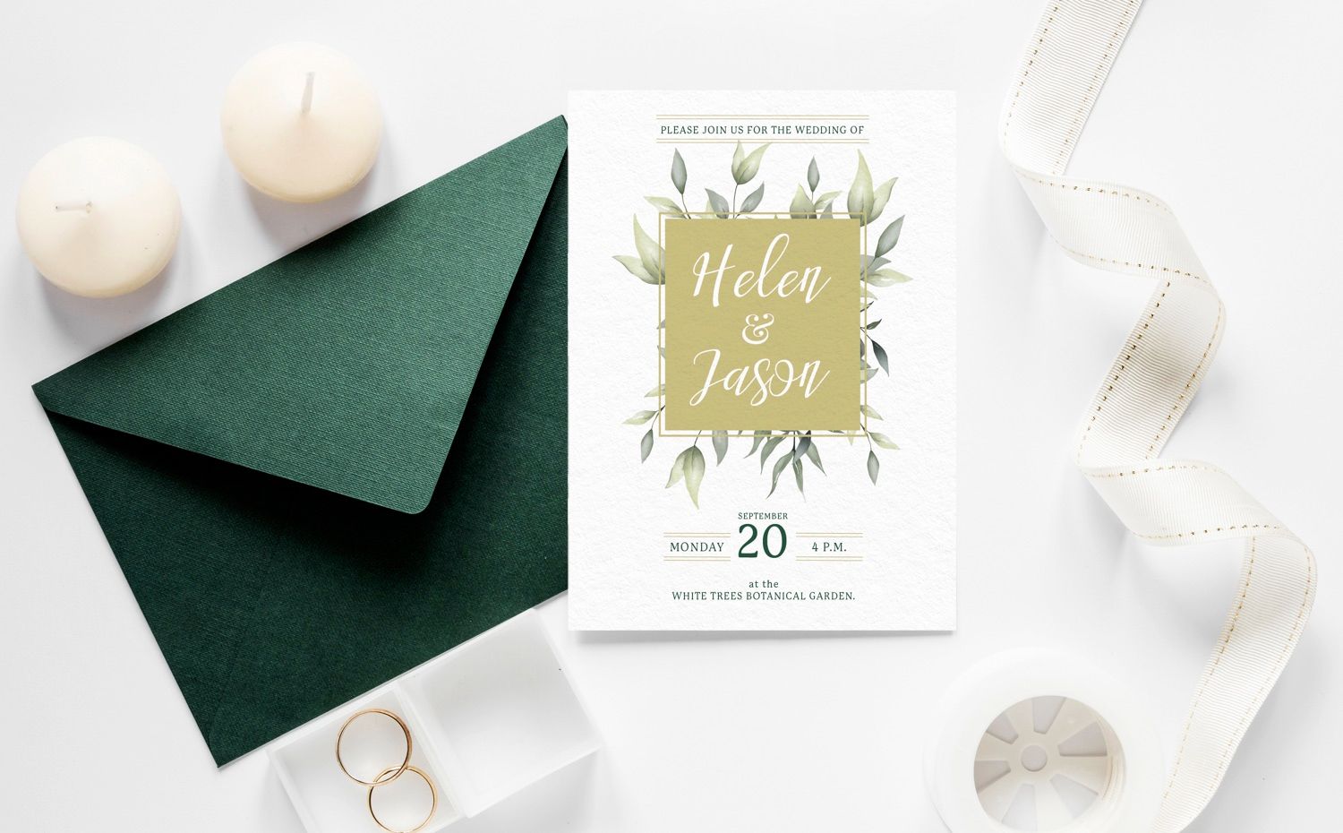 A wedding invitation is sitting on top of a green envelope.