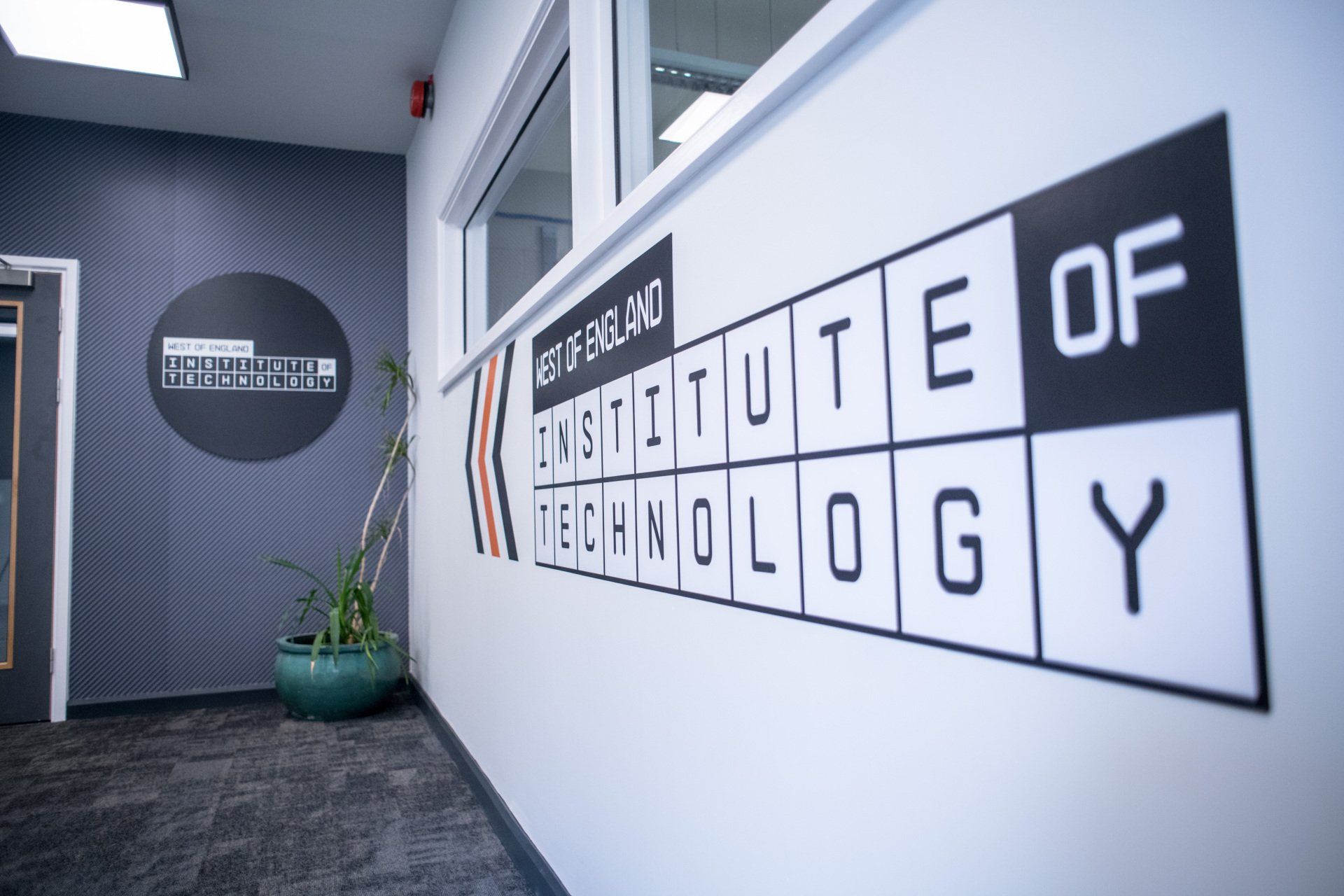 A hallway with a sign on the wall that says institute of technology
