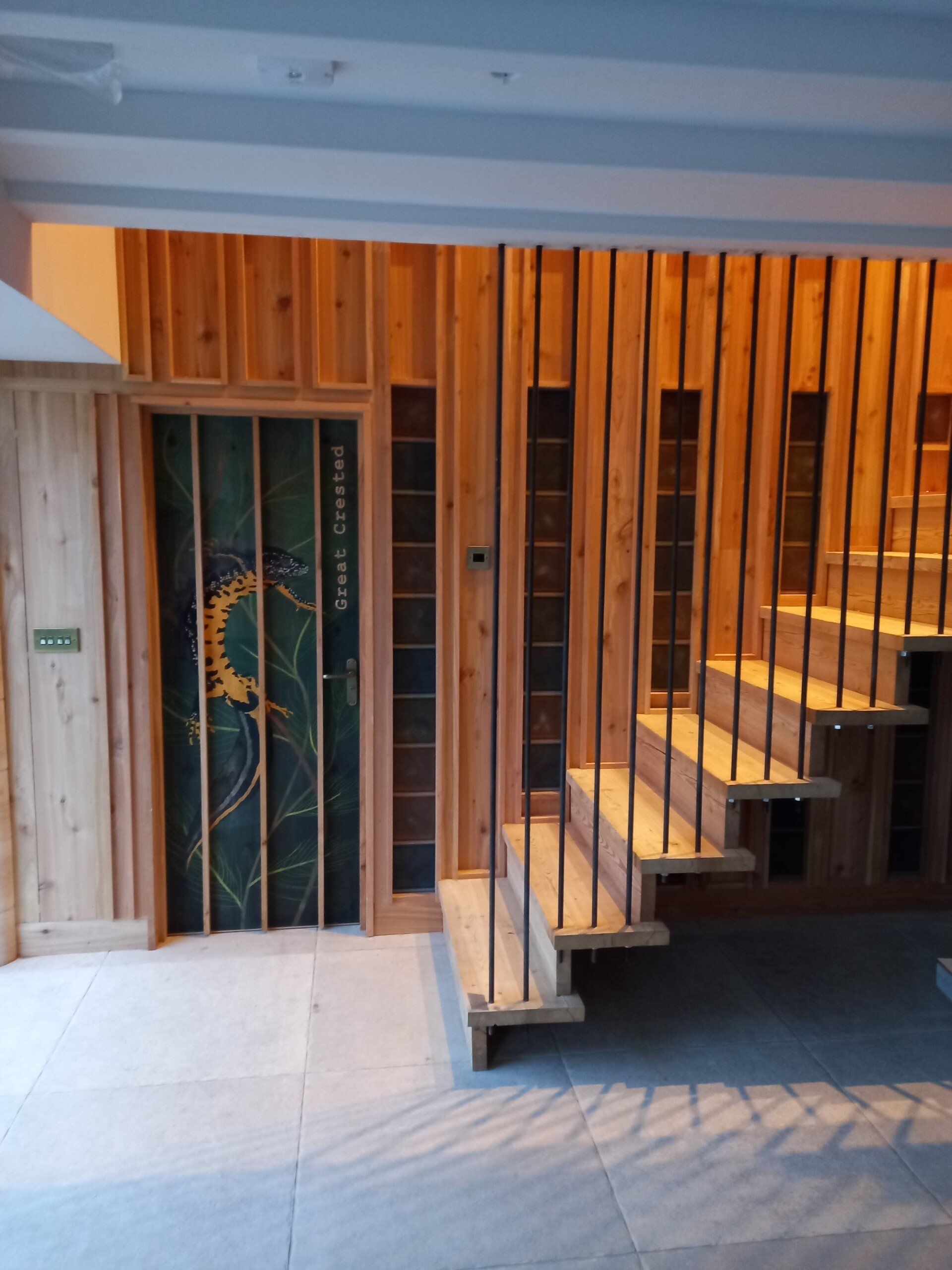 A wooden staircase with a door that says ' tower ' on it