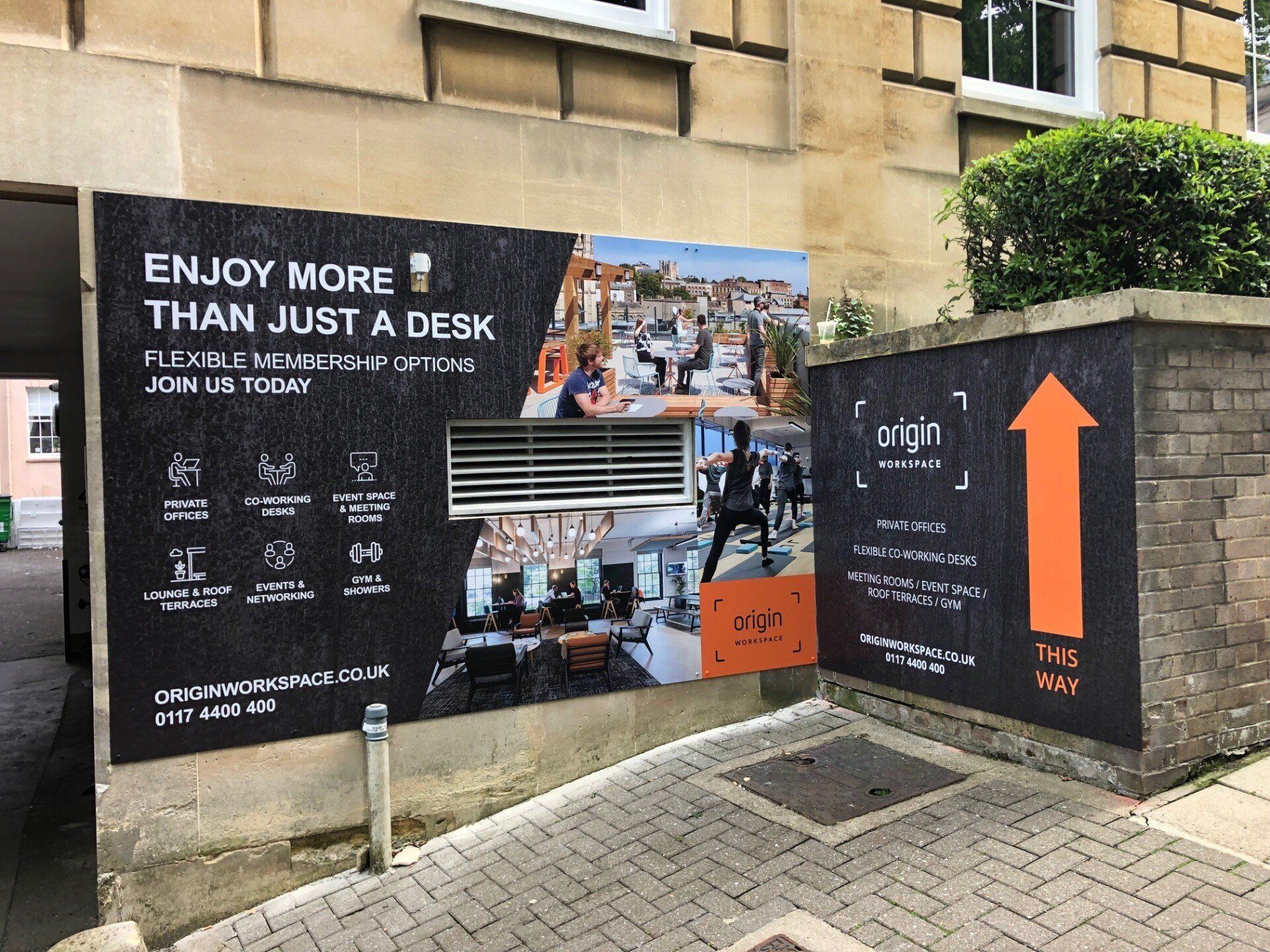 A sign on the side of a building that says `` enjoy more than just a desk ''.