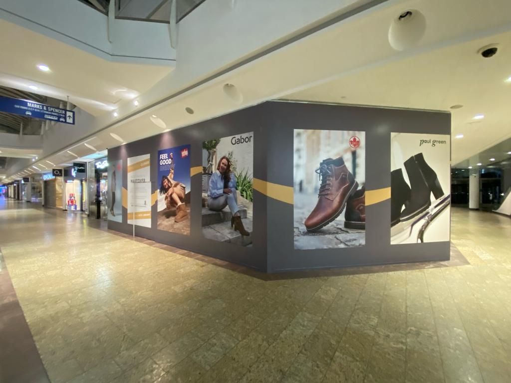 A wall with a lot of pictures of shoes on it