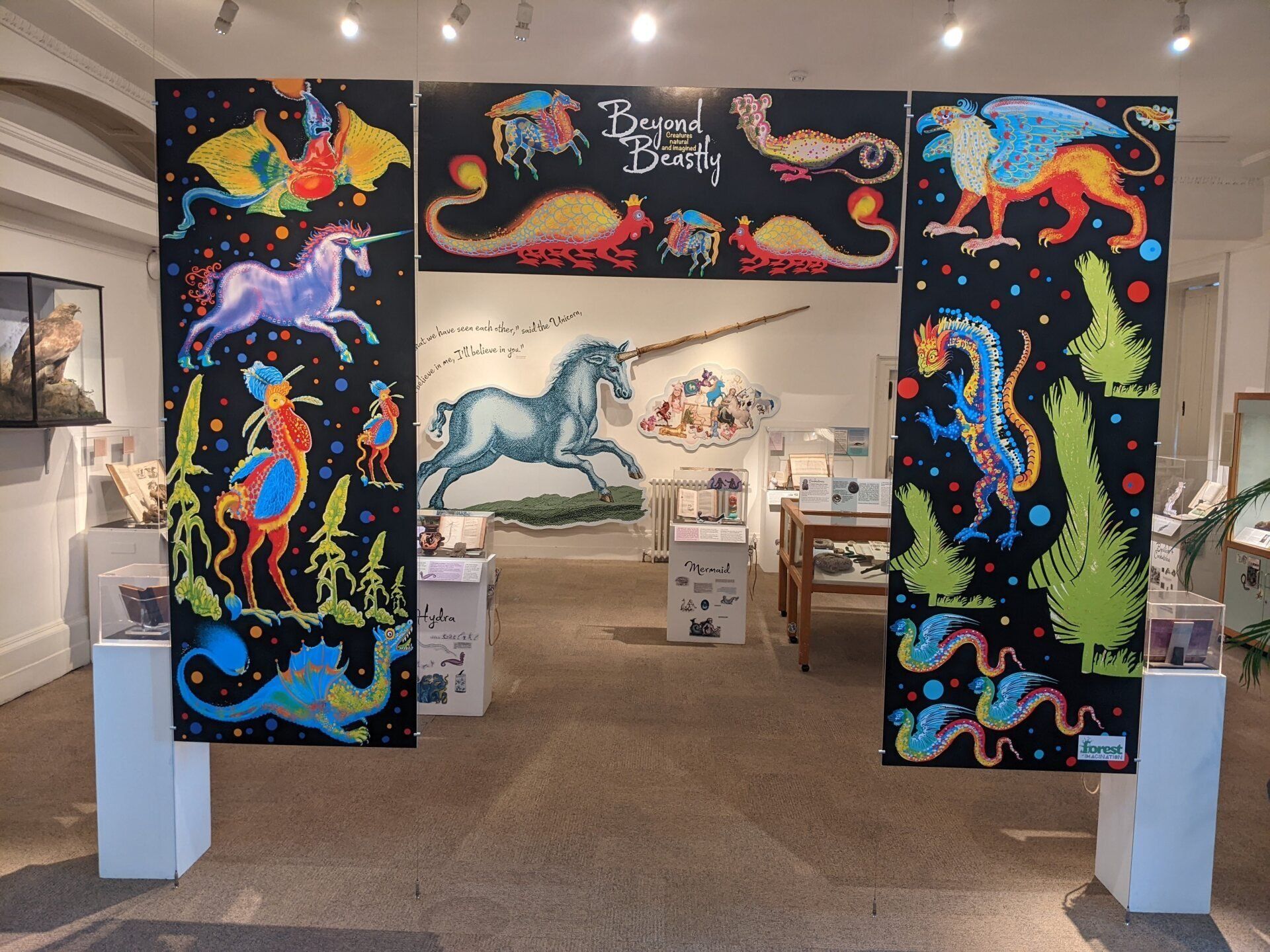 A painting of a unicorn is on a wall in a room
