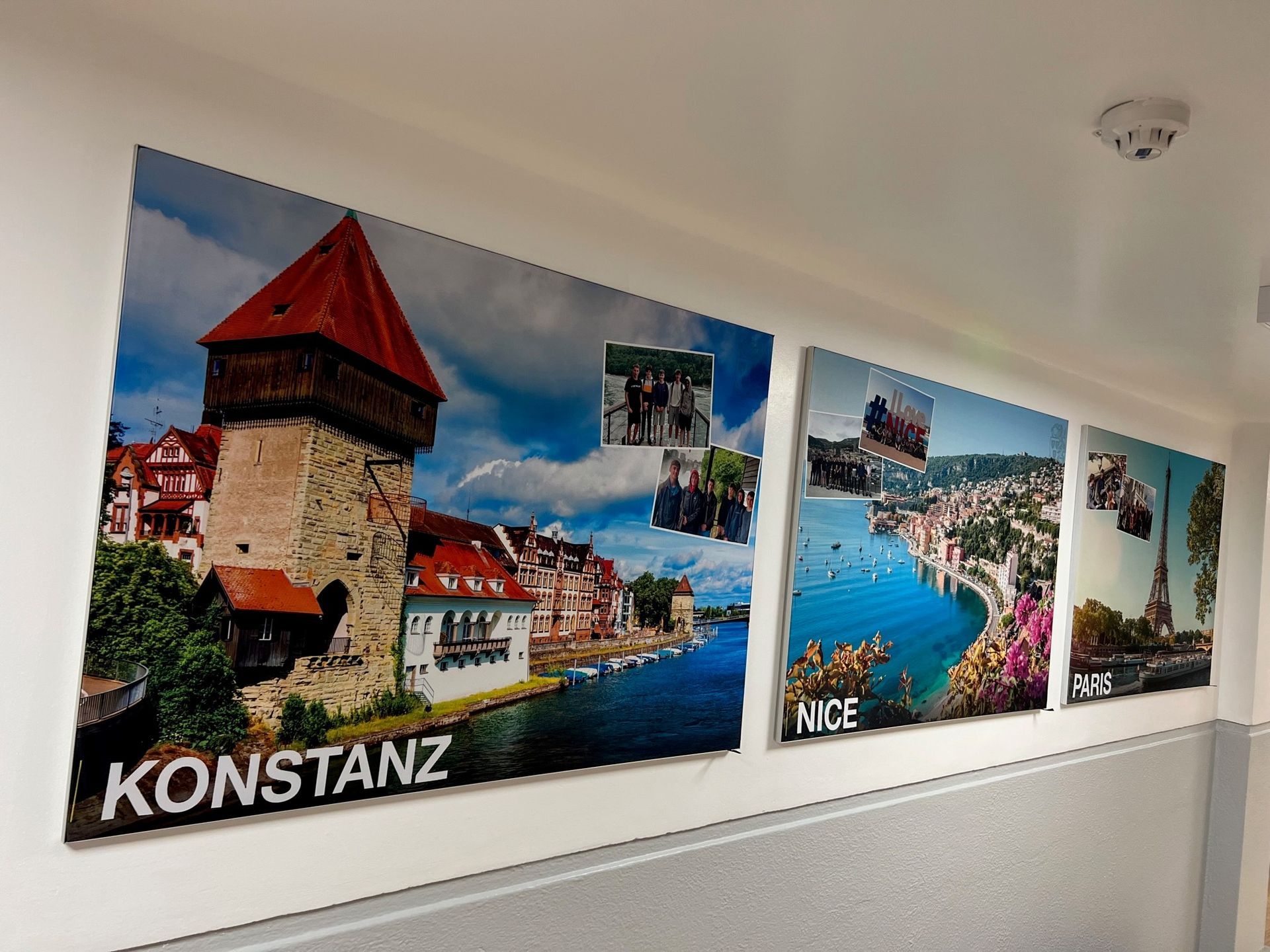 A row of posters on a wall with one that says konstanz