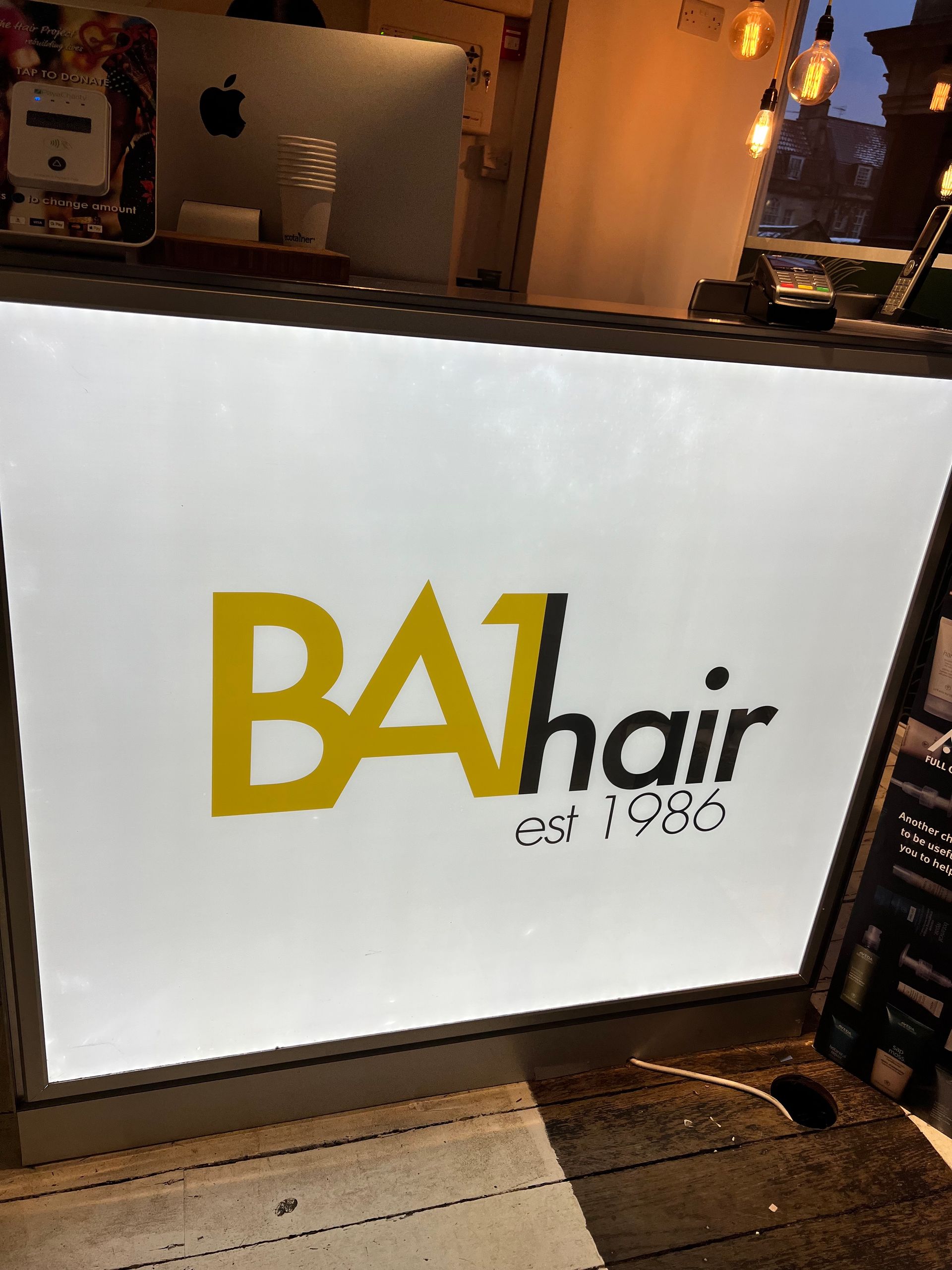 A white sign that says balhair on it