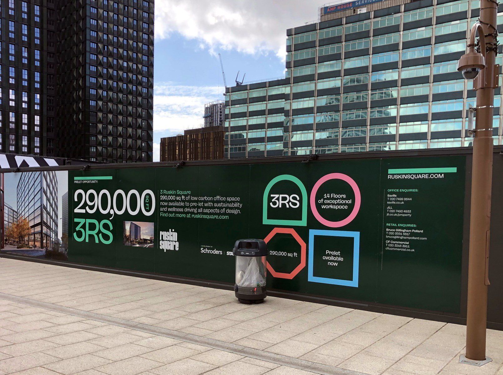 A green fence with a sign on it that says 290,000 3rs