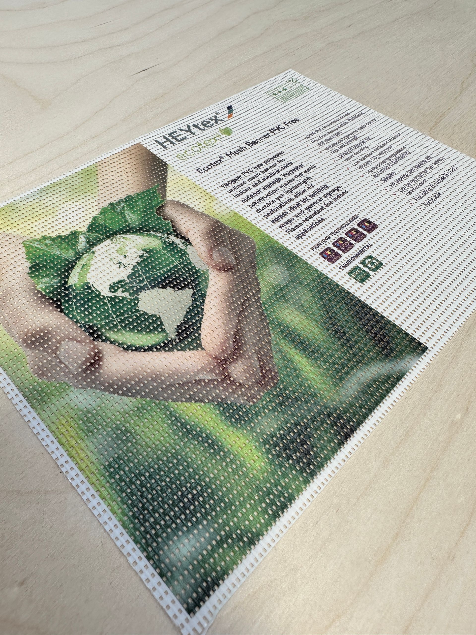 A person is holding a green globe in their hands.