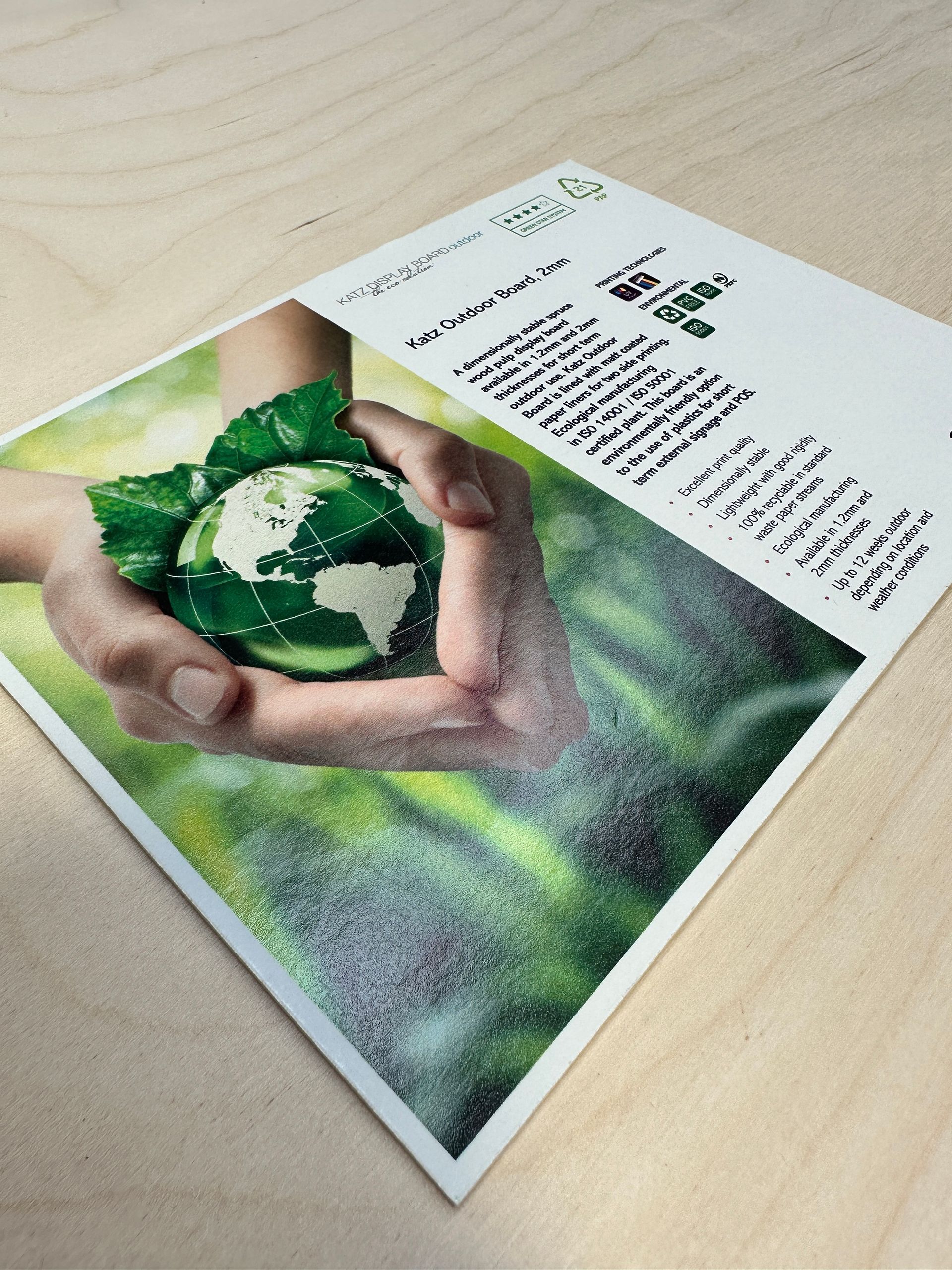 A person is holding a green globe in their hands