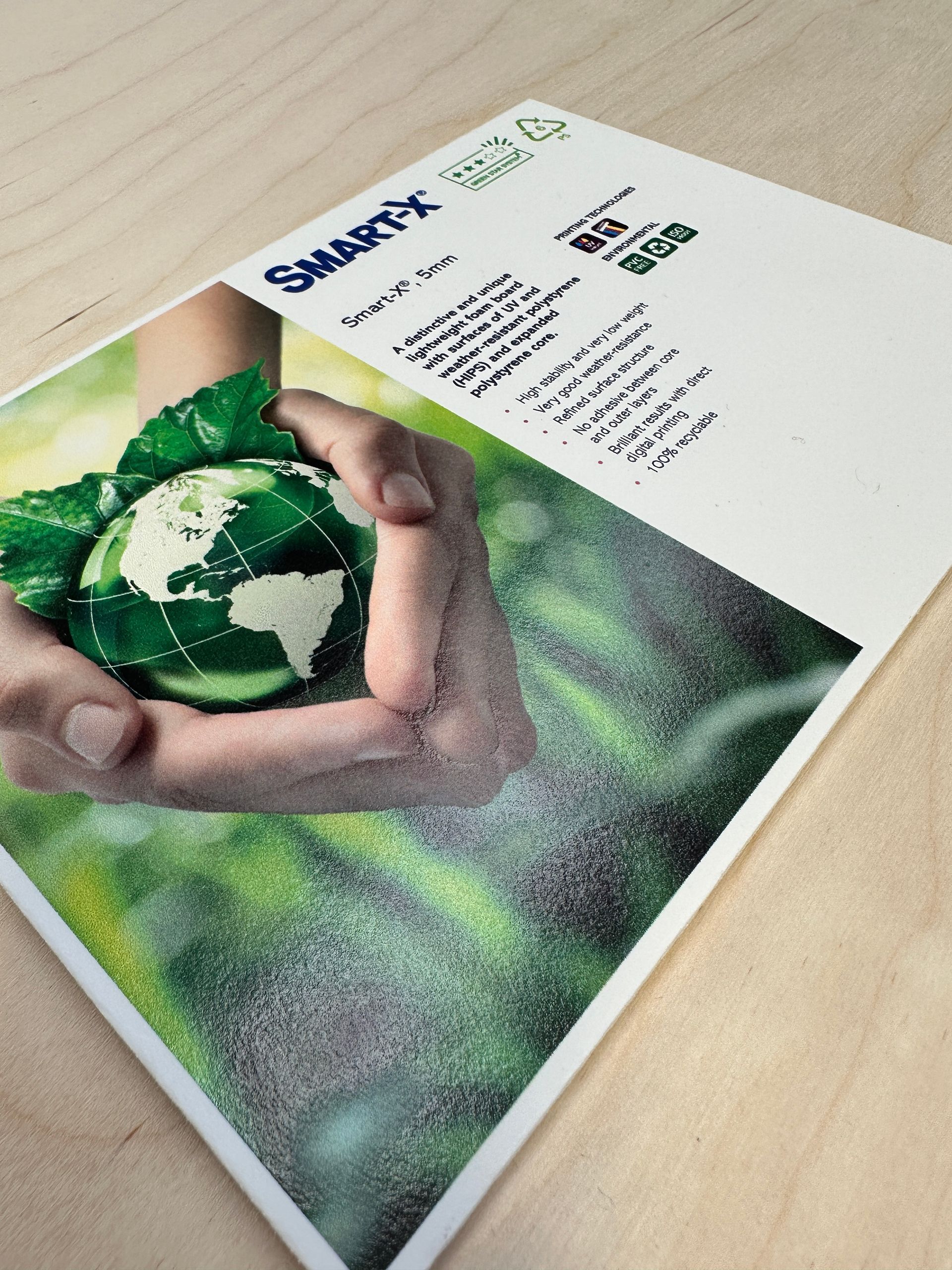 A person is holding a green globe in their hands