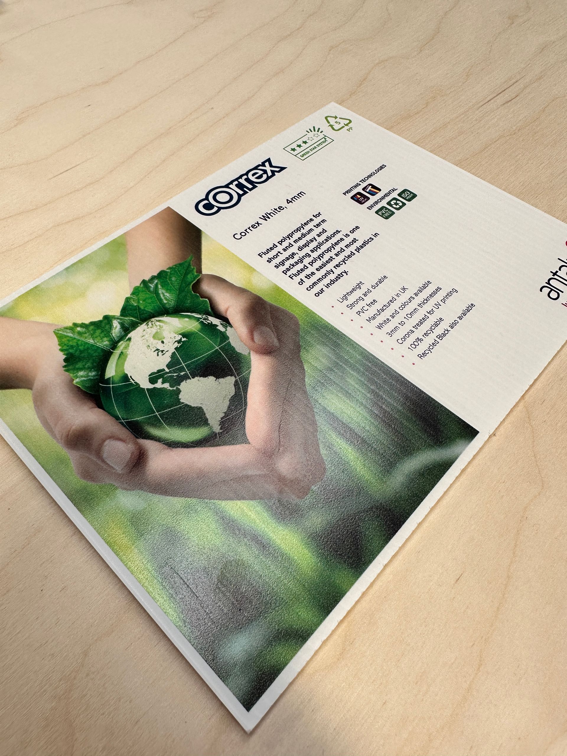 A card with a picture of a person holding a globe in their hands