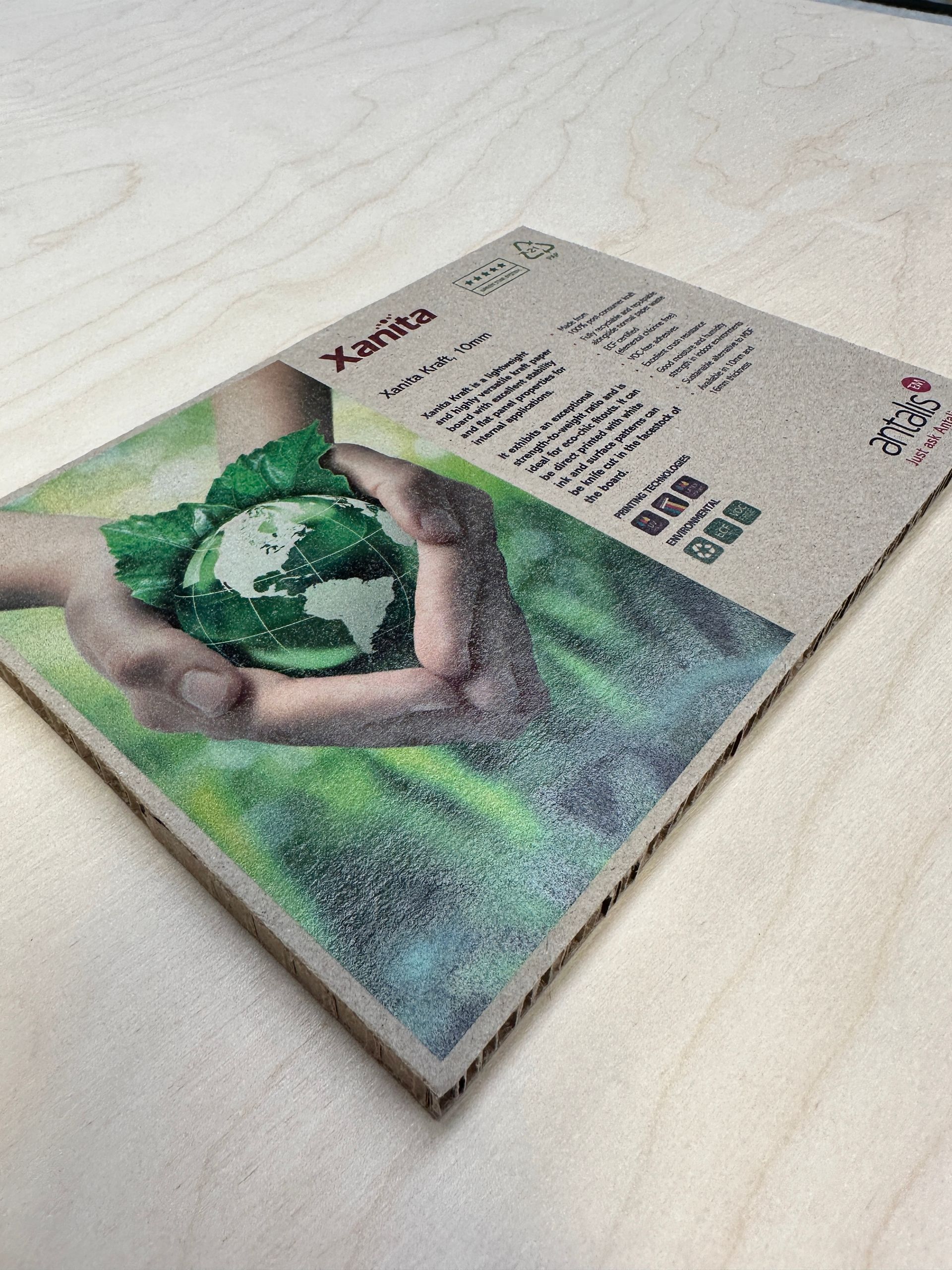 A cardboard box with a picture of a person holding a globe in their hands.