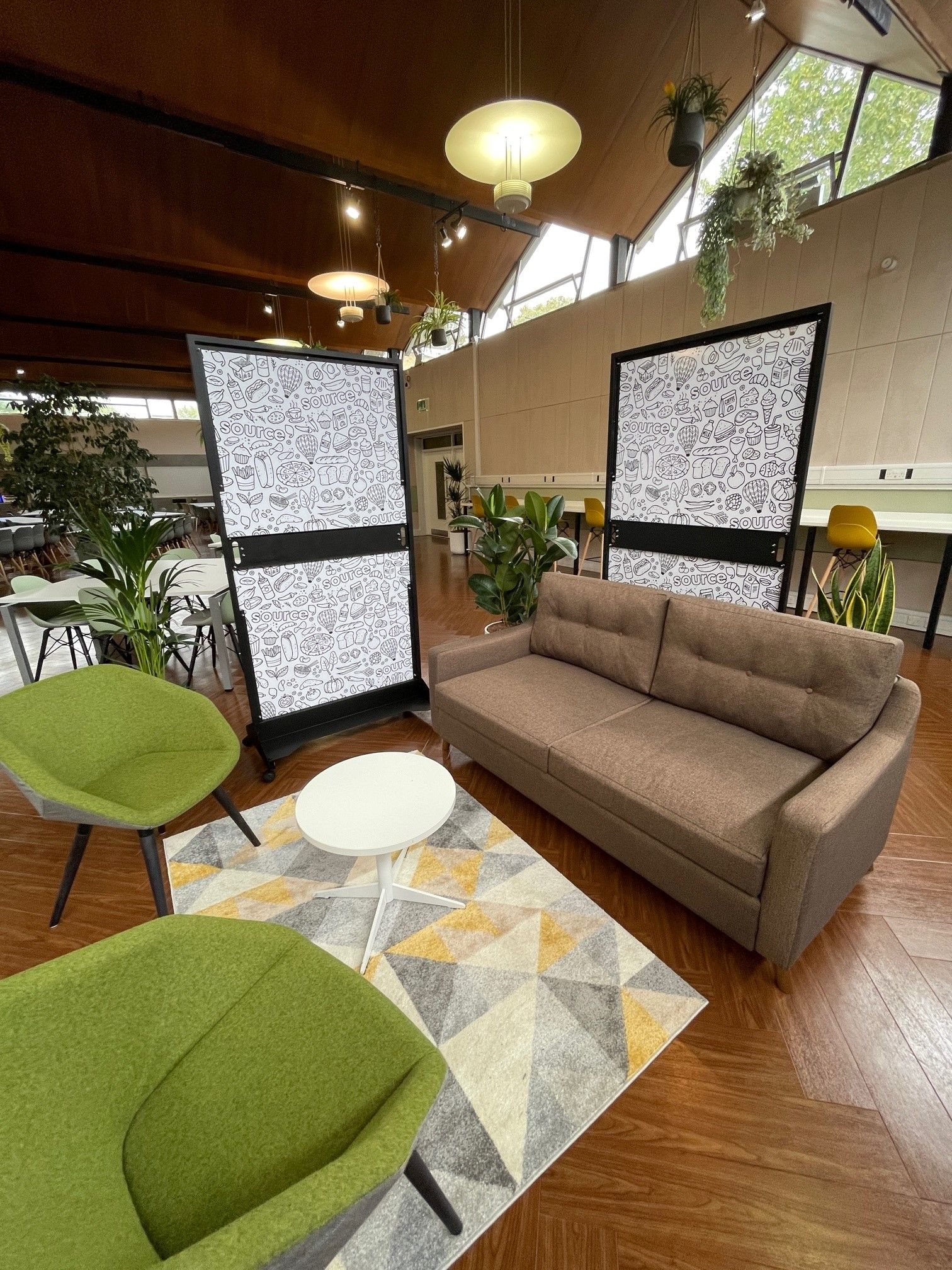 A living room with a couch , chairs , and a rug.