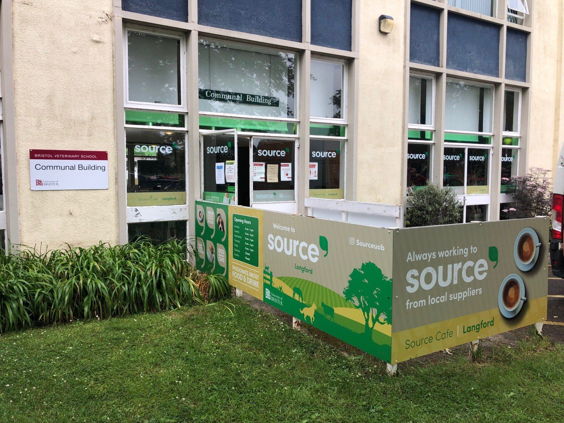 A large building with a sign that says source on it.