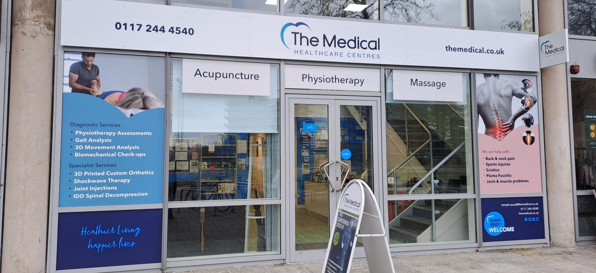 A person is walking in front of a store called the medical