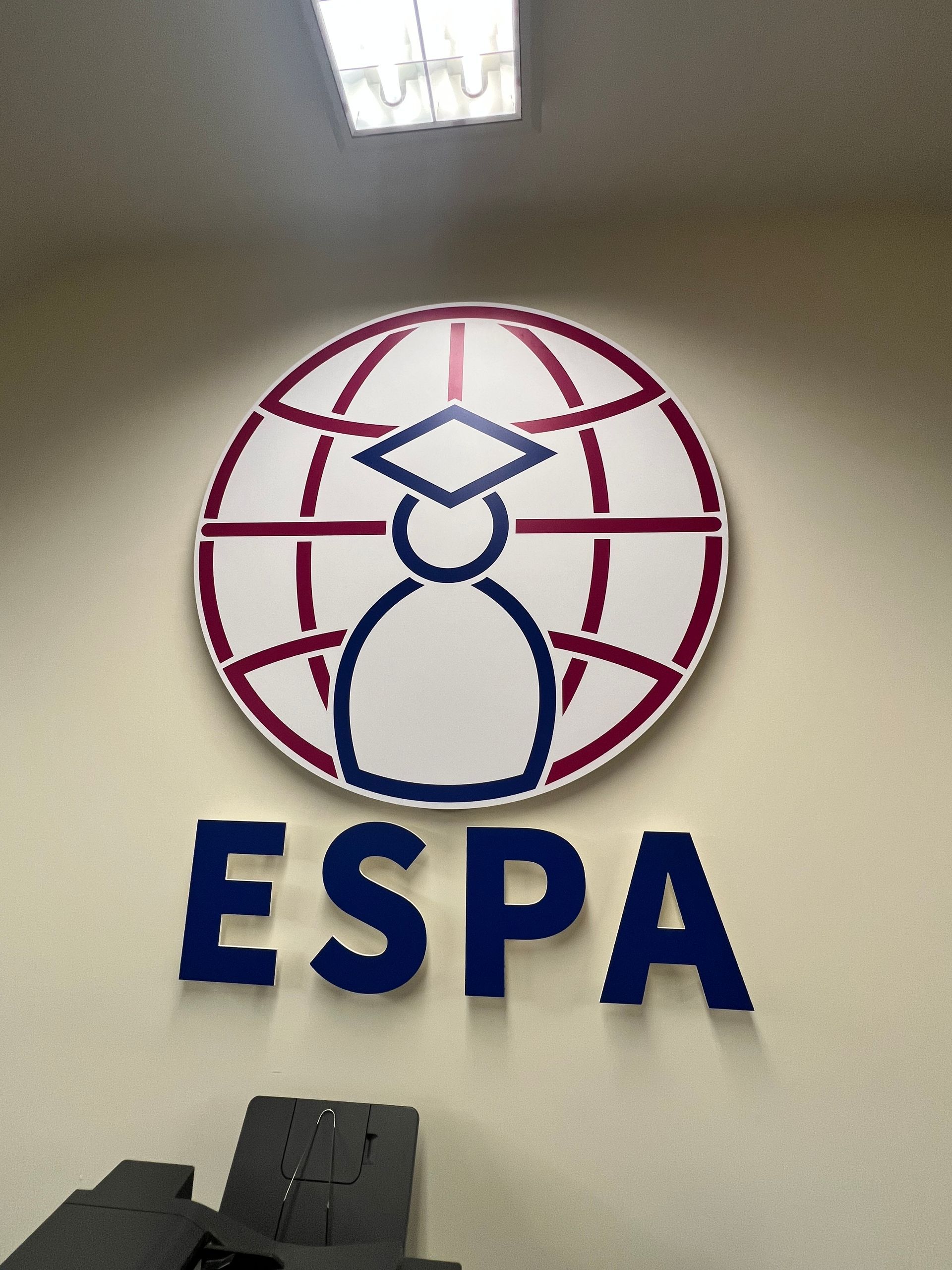 A logo for espa with a globe and a graduation cap