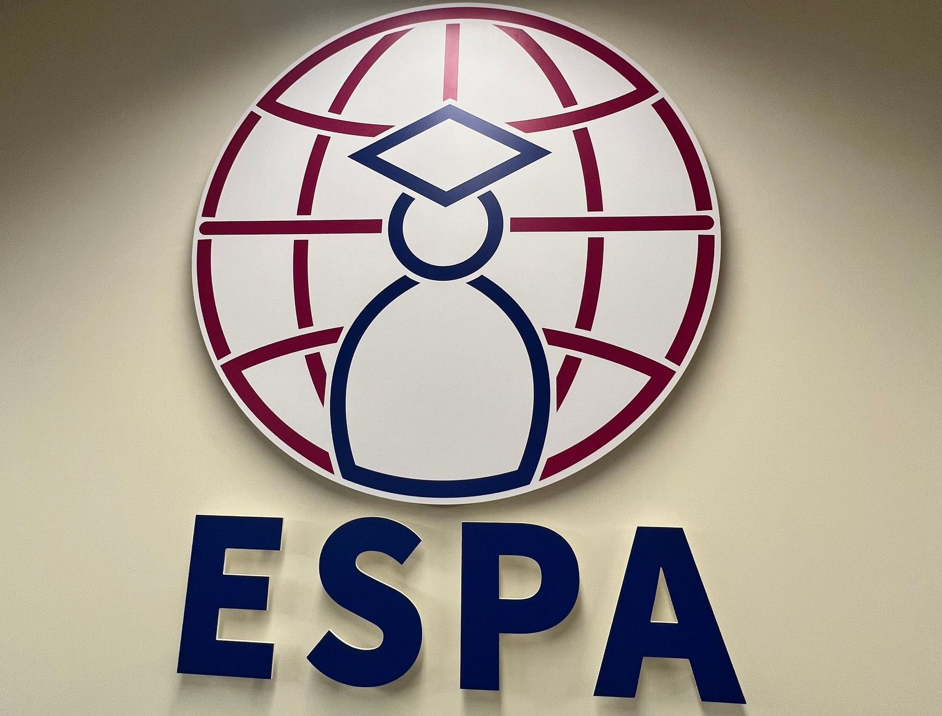 A logo for espa with a globe and a graduation cap