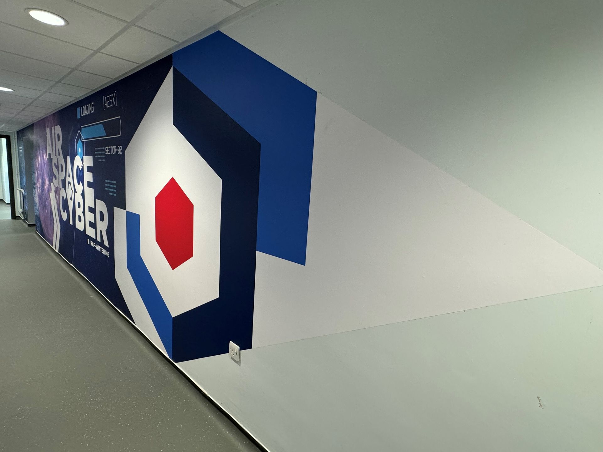 A long hallway with a mural on the wall that says peace cyber