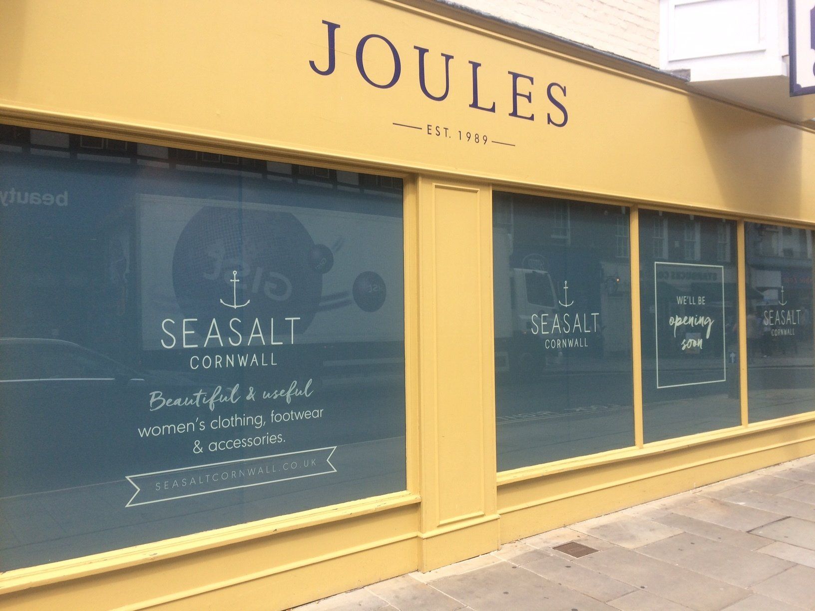 A yellow building with a sign that says joules on it