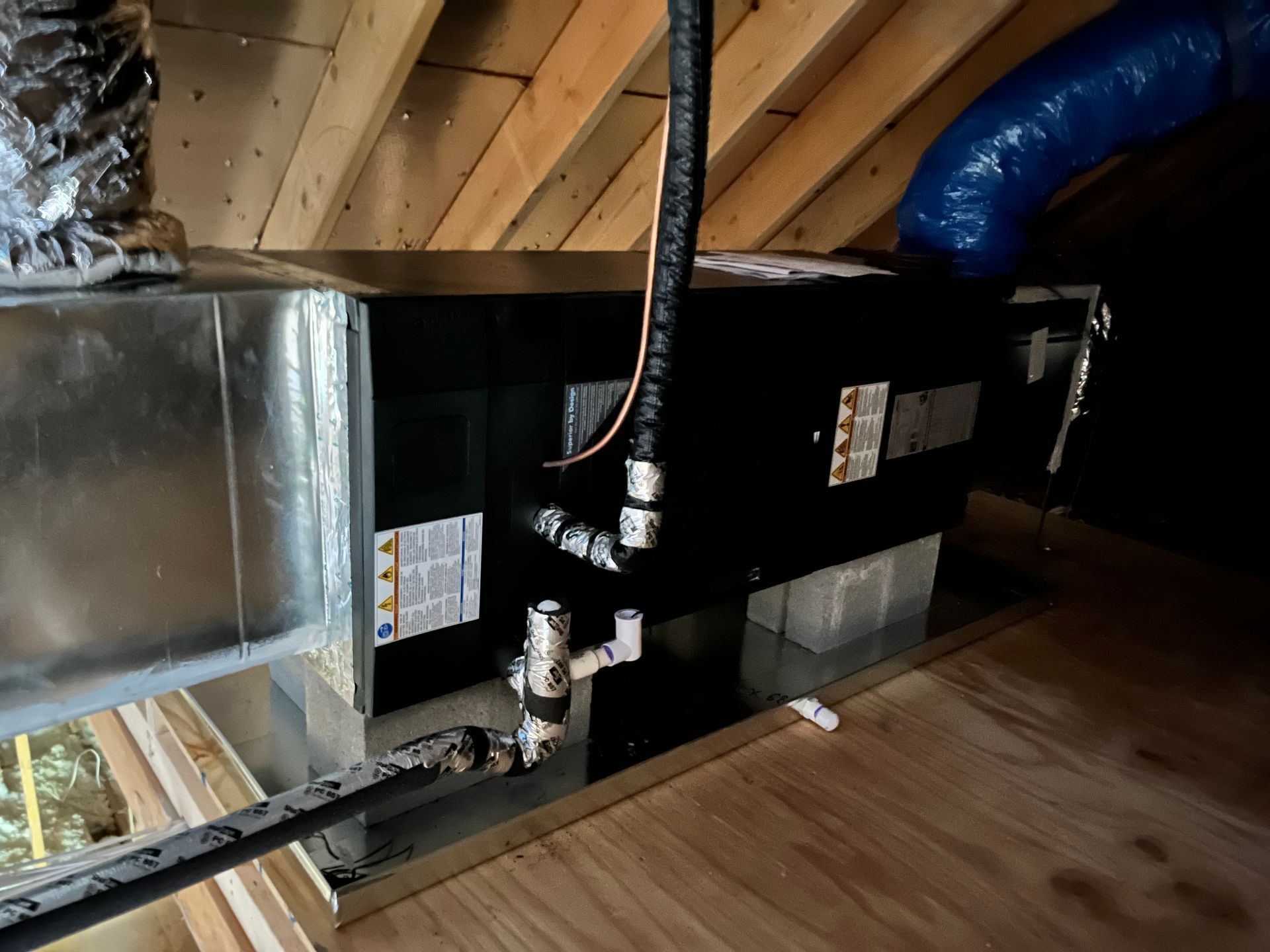 an air conditioner is installed in the attic of a house