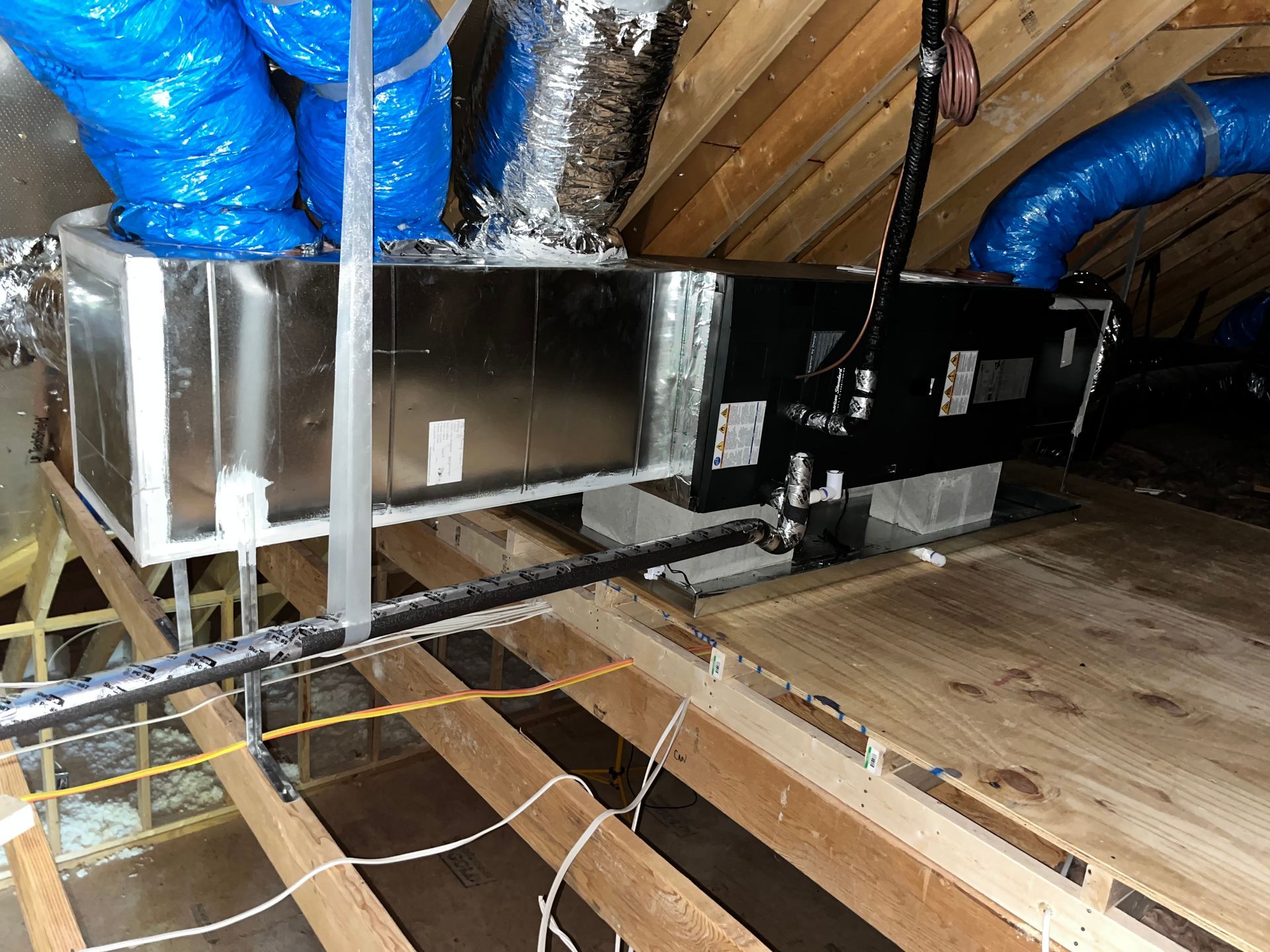 a ventilation system is being installed in the attic of a house .