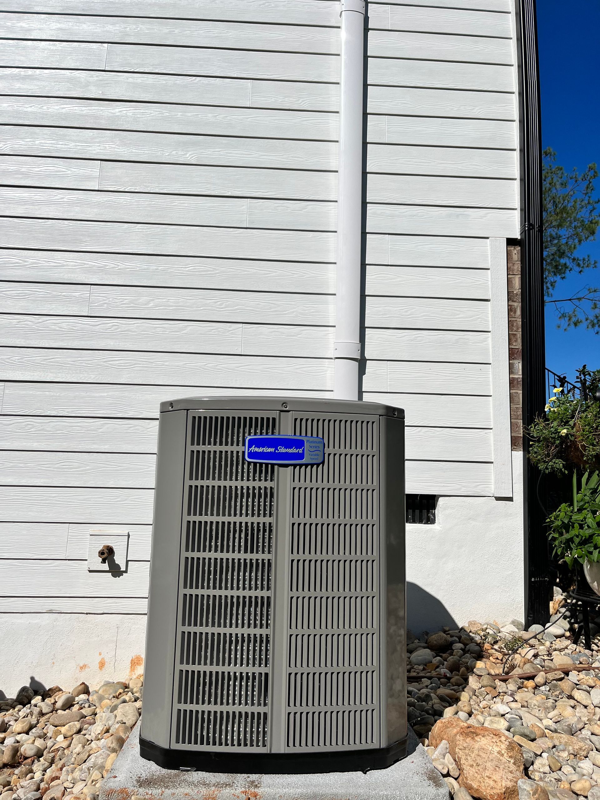 an air conditioner is sitting on the side of a house .