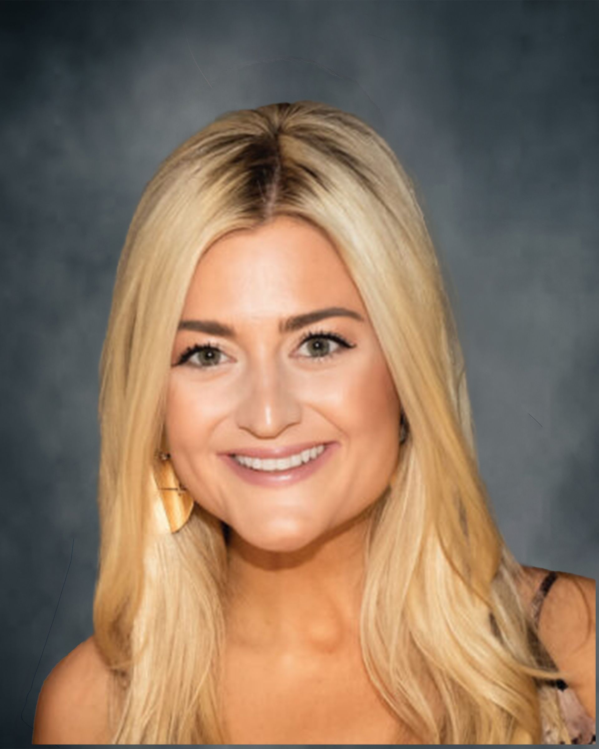 Portrait of a smiling blonde woman against an indoor background
