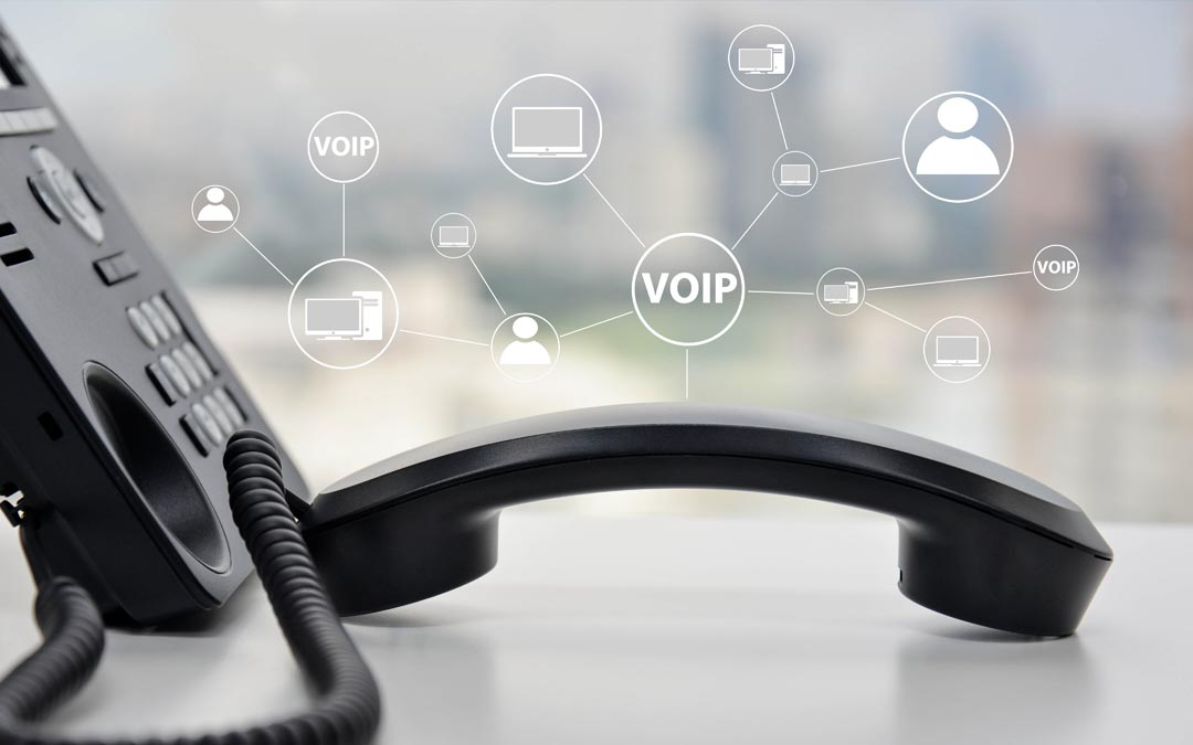Telefono VoIP nero con ricevitore sganciato, sfondo sfocato dell'ufficio, icone di rete connesse.