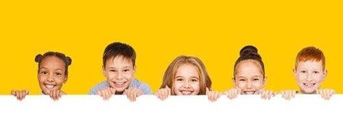Five children peeking over a white banner on a yellow background, smiling