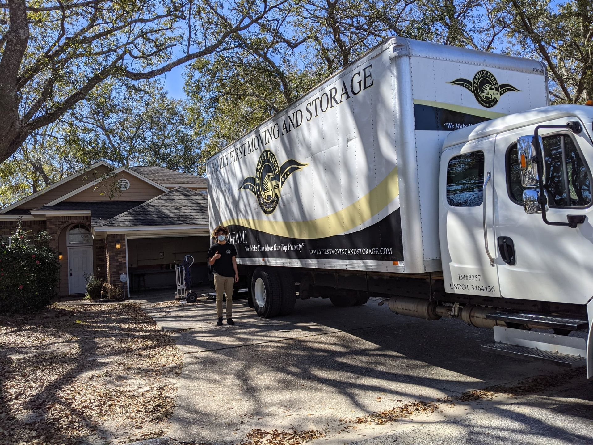 A moving truck is parked in front of a house.