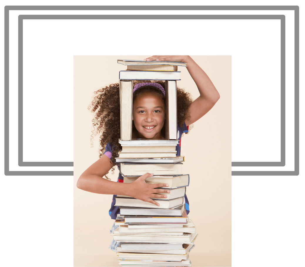 A young girl is holding a stack of books. Dramatherapy Ireland