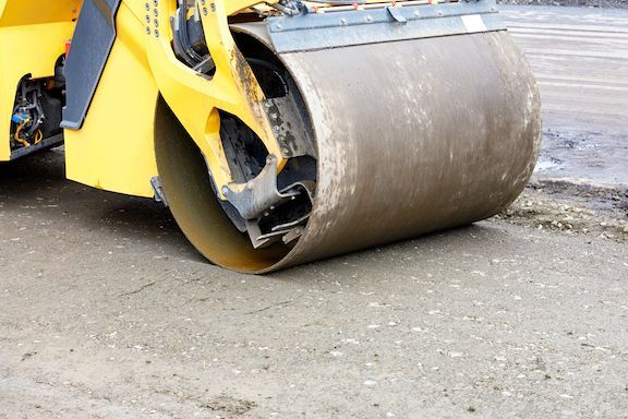 concrete flatwork, shows bulldozer installing a concrete driveway