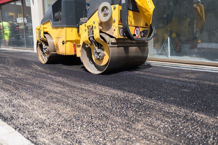 blacktop paving contractors using an asphalt roller in Union City, PA
