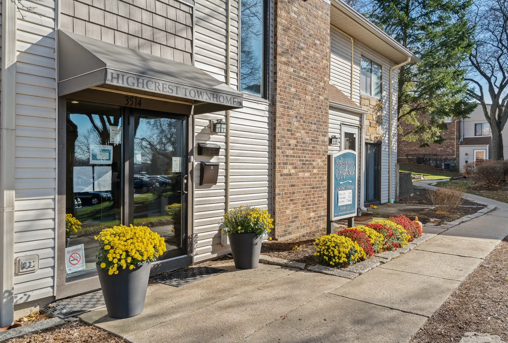 Exterior view of Highcrest Townhomes entrance with flower pots.
