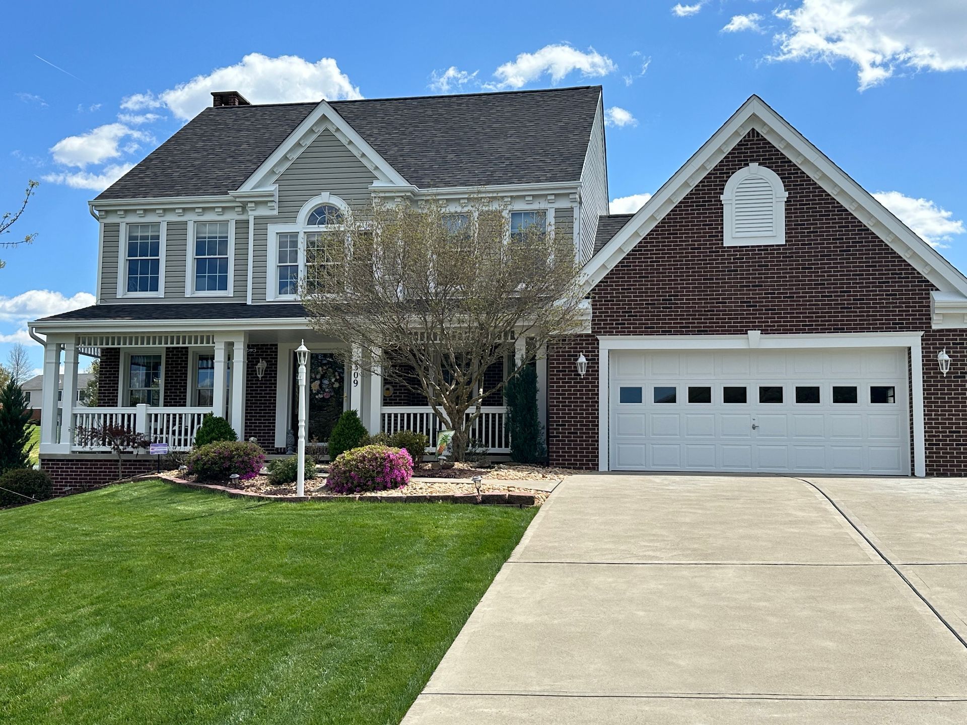 A large brick house with a white garage door
