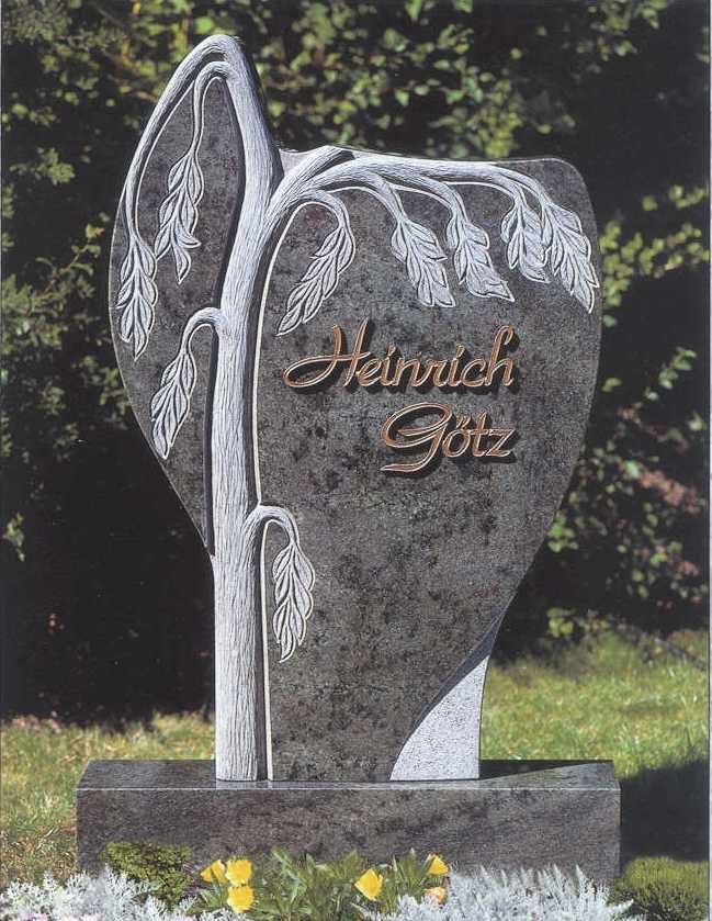 Gray granite tombstone with carved tree design,