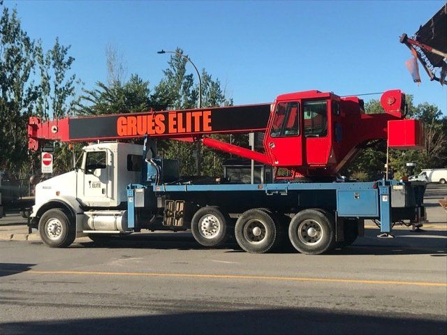 A grues elite truck is parked on the side of the road
