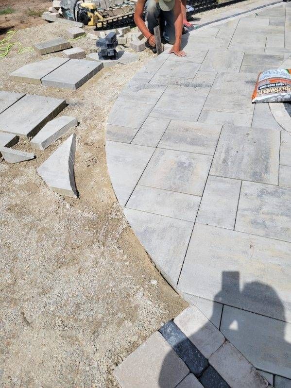 Paver walkway installation in progress with custom cuts and base preparation in Janesville, WI.